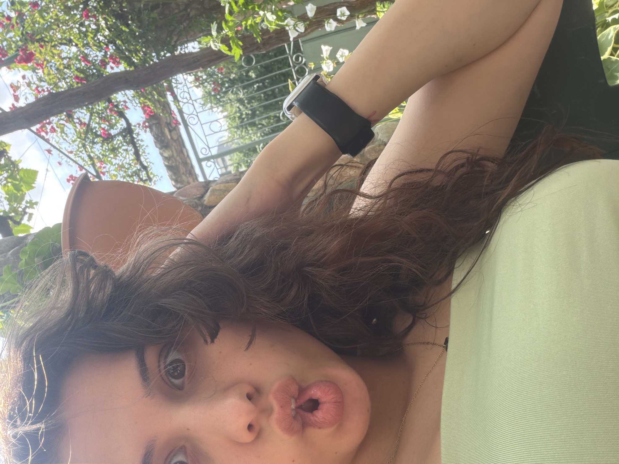 Person photographed in garden setting during afternoon hours