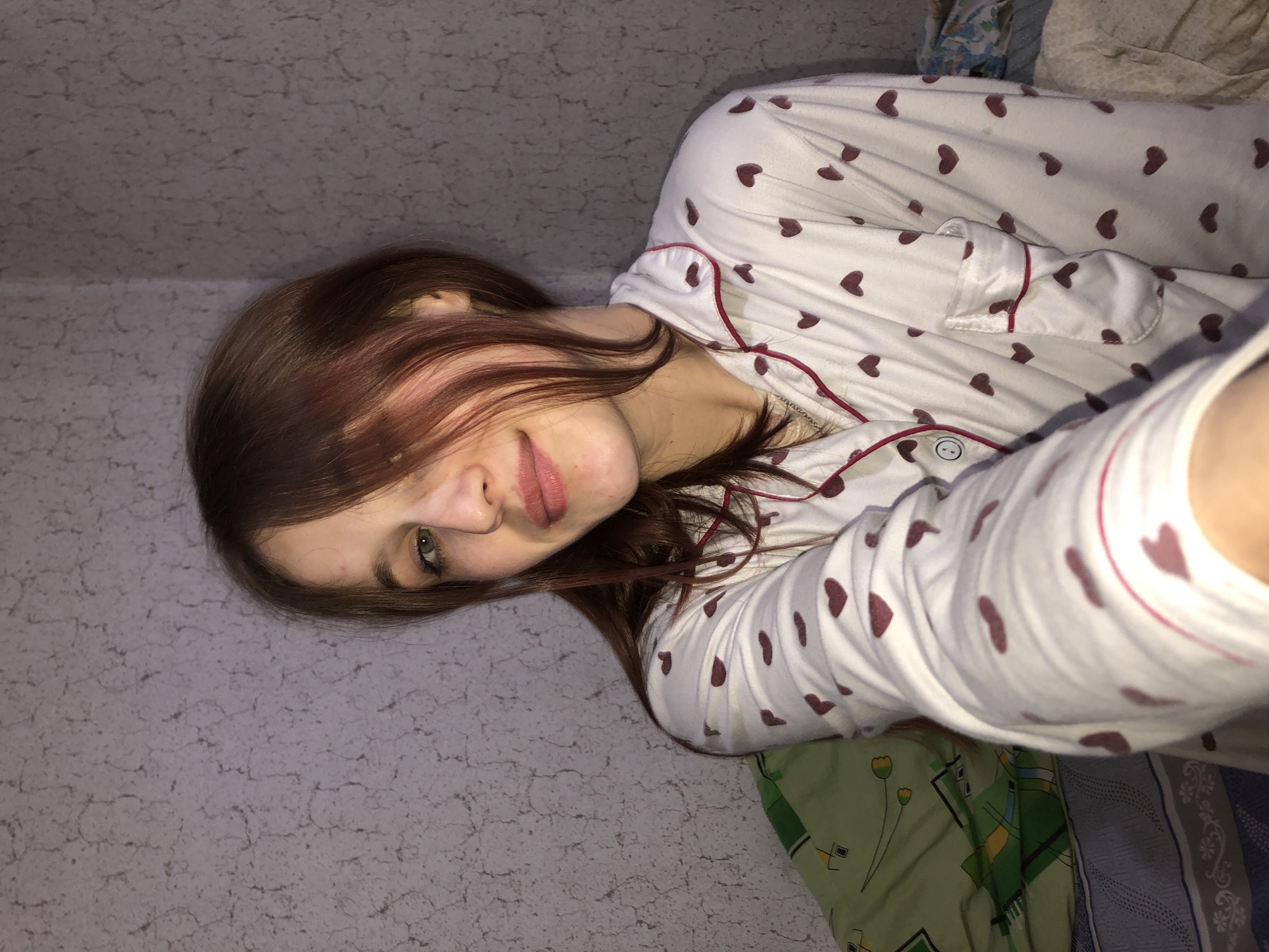 Woman and child share quiet moment on bed in Russia