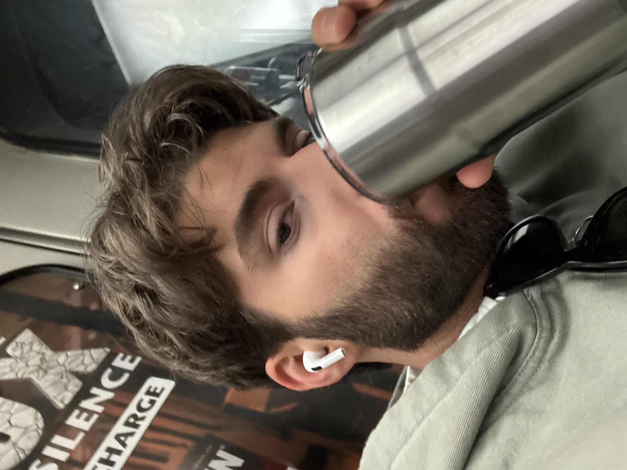 Man drinks from travel mug on Montreal public transit