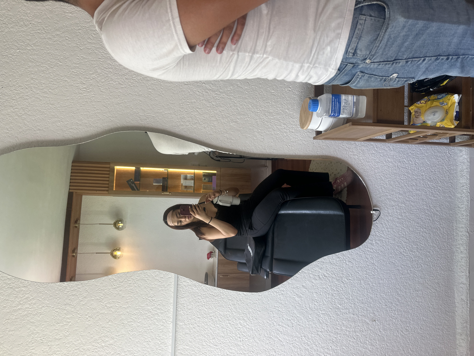 Woman takes mirror selfie during filming session in Puebla