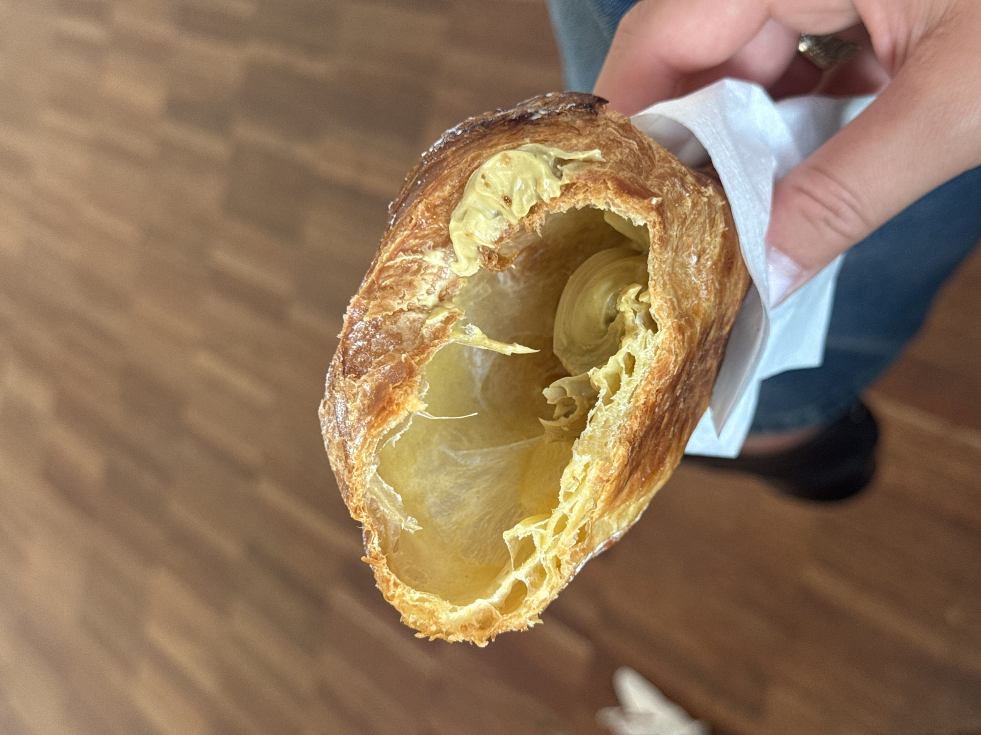 Person enjoys filled croissant in early morning Orio al Serio