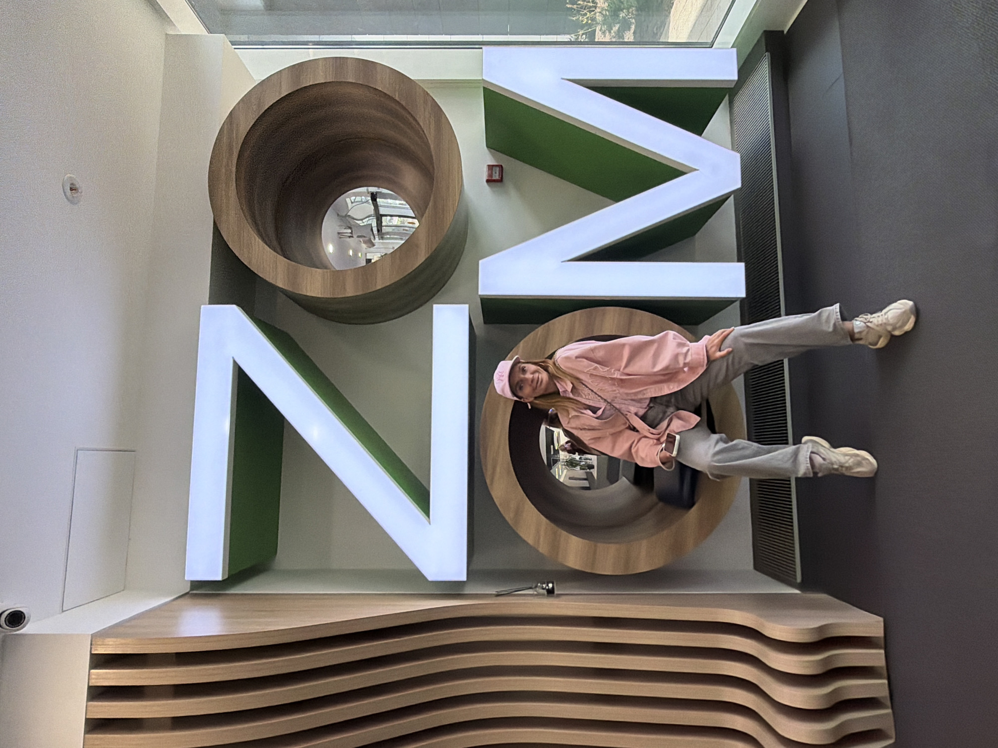 Woman poses with interactive letter art at Saint Petersburg hotel