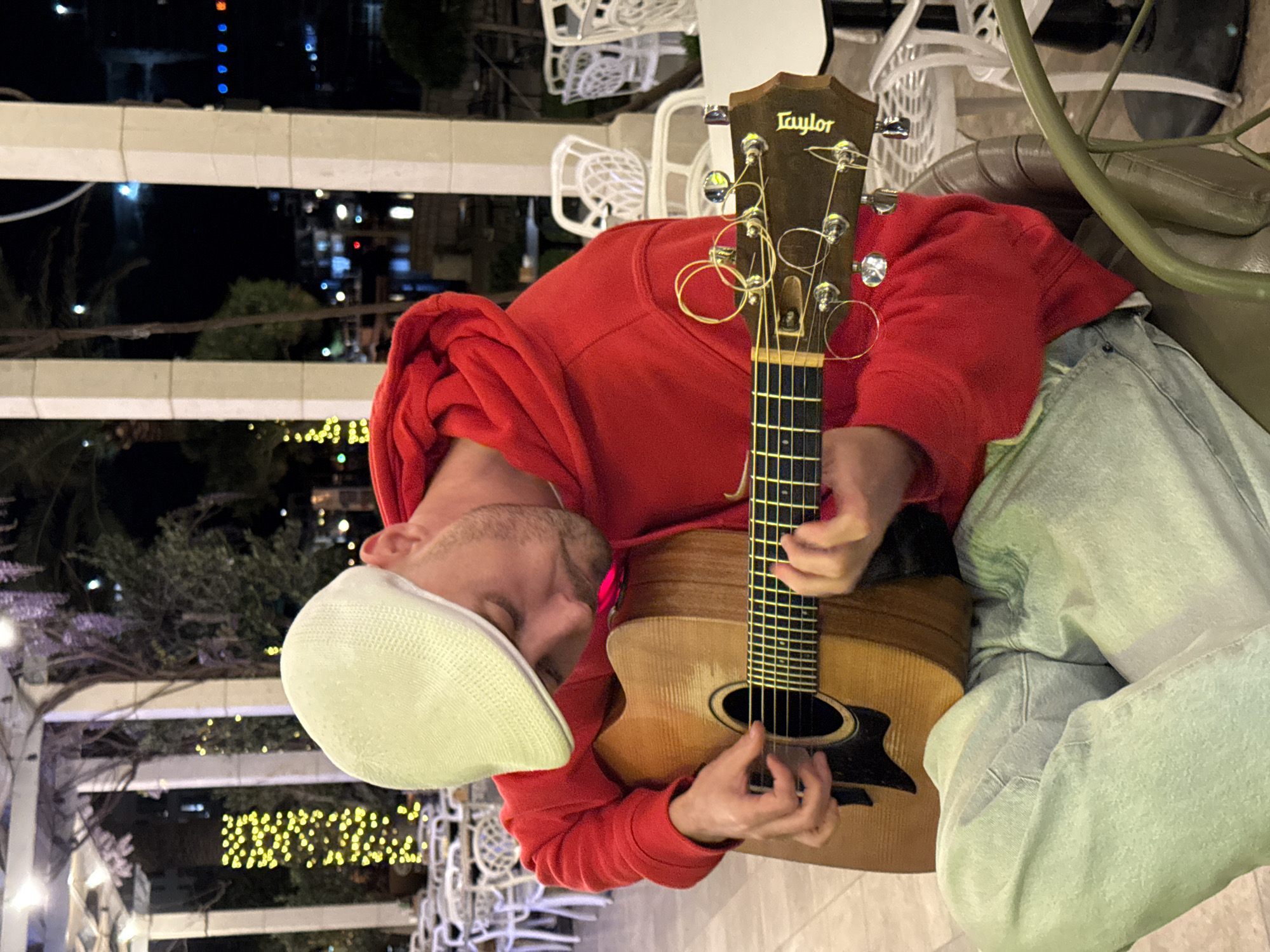 Street musician plays acoustic guitar outdoors in Montenegro