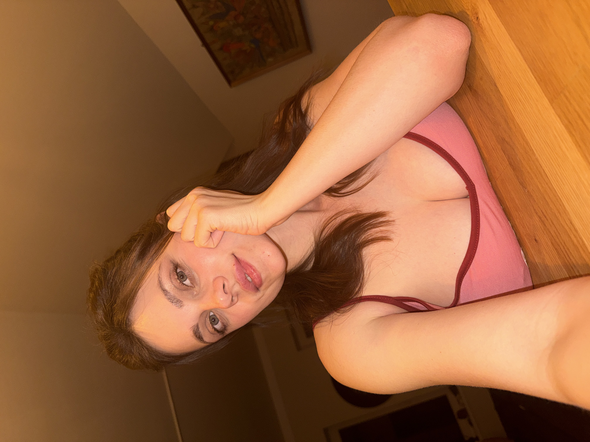 Woman photographed in casual indoor setting near dartboard in Budapest