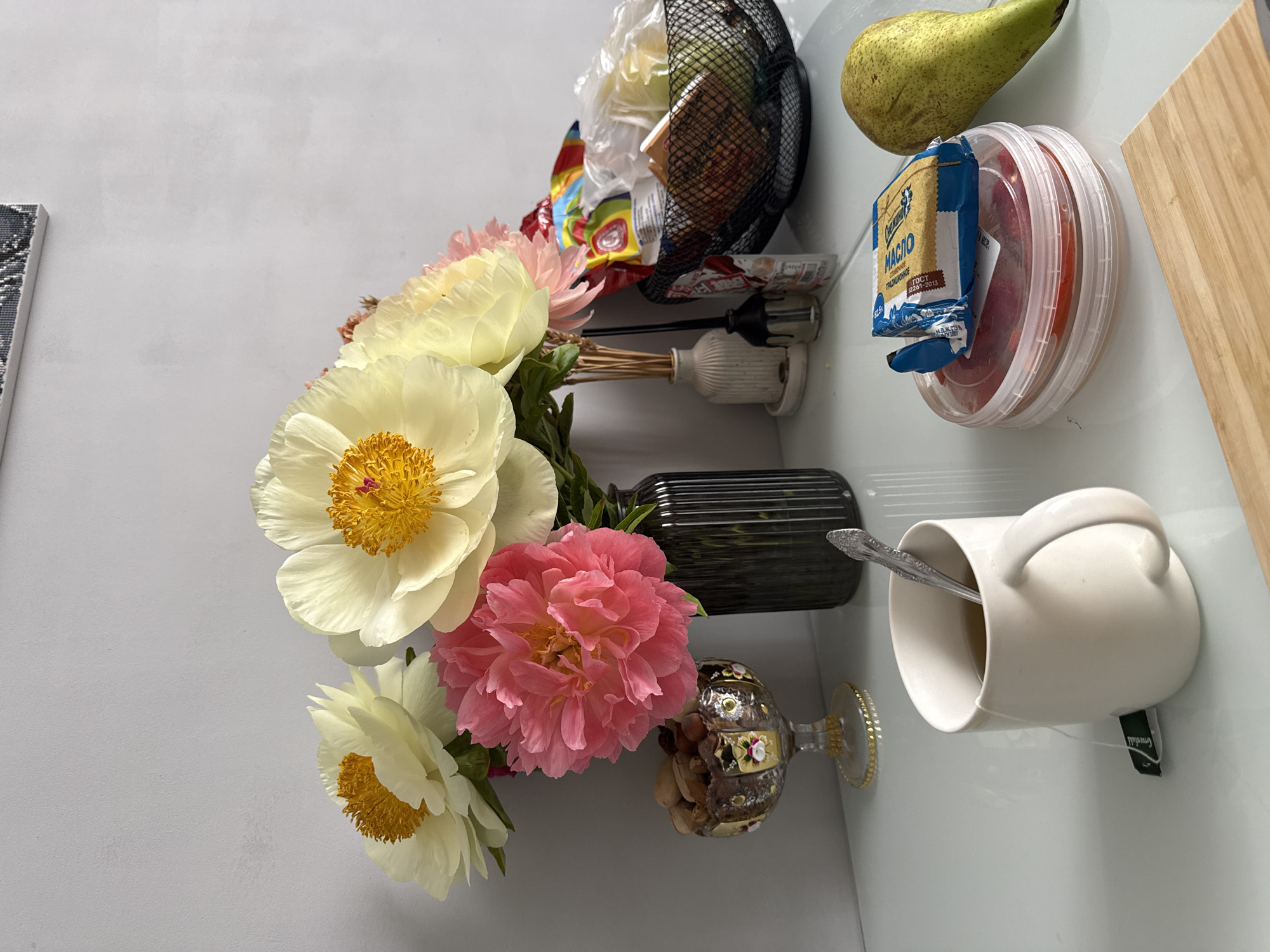 Peony bouquet arranged in still life display near window