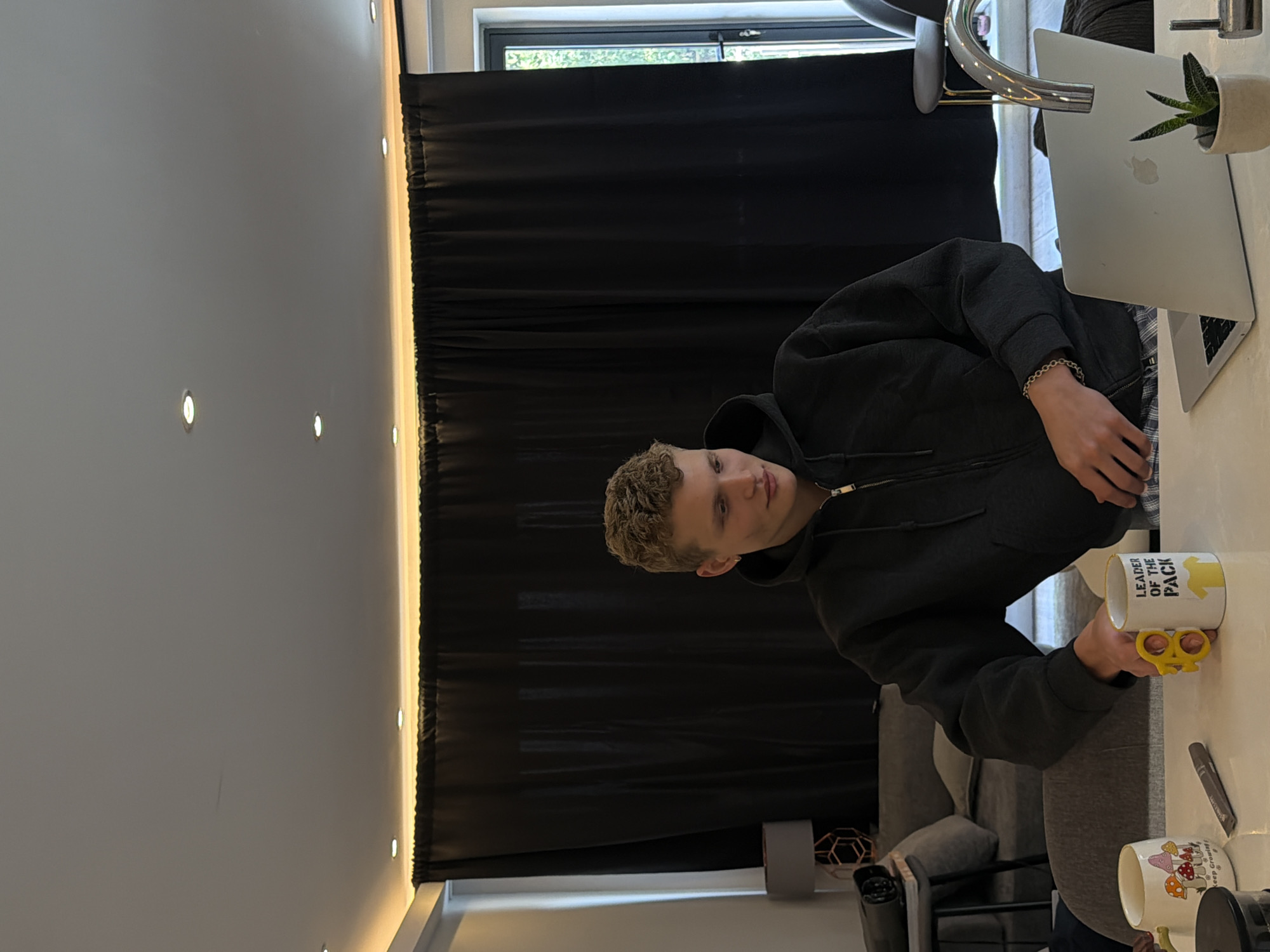 Young man works at laptop in London cafe