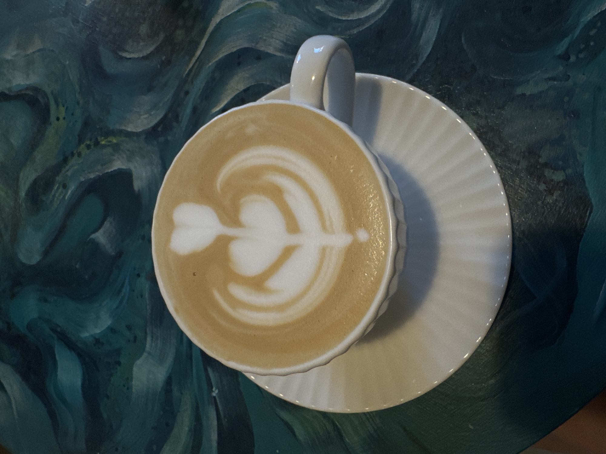 Woman enjoys coffee with latte art at Minsk cafe