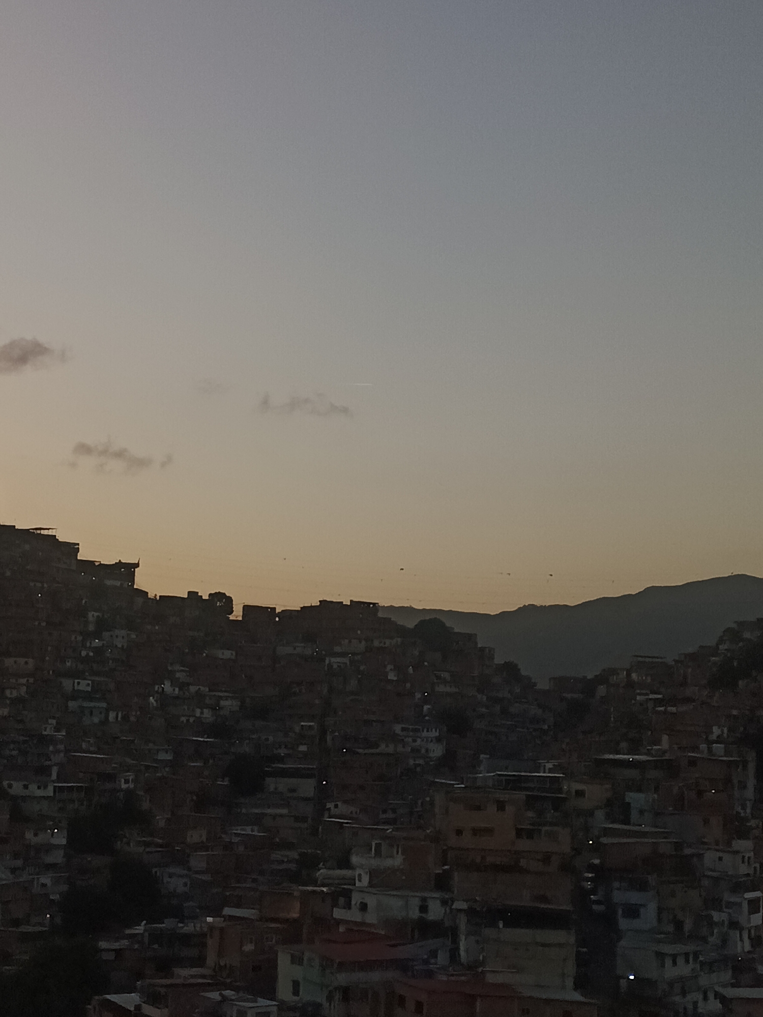 Caracas at sunset, hillside barrios and apartment windows