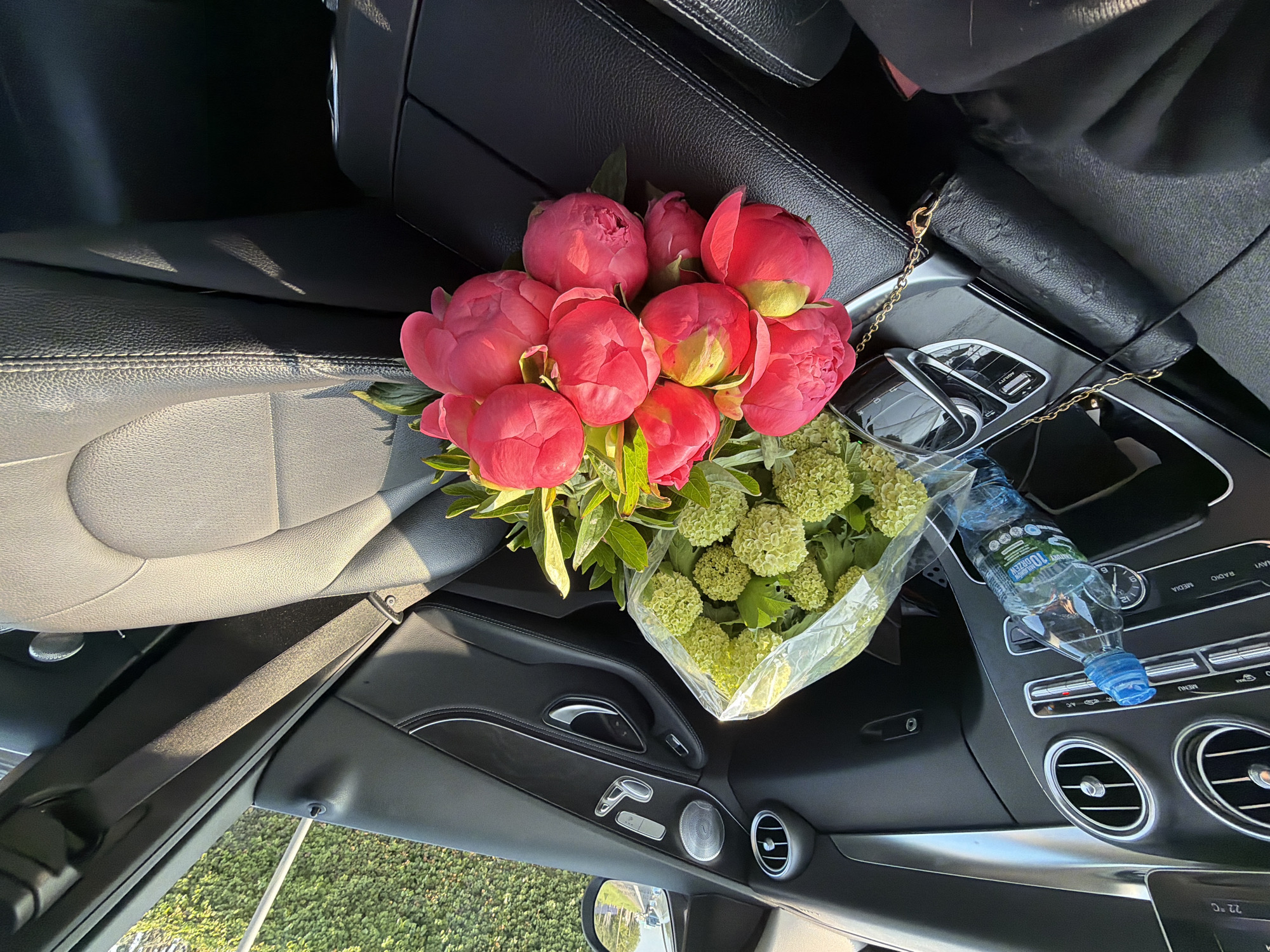 Woman documents flower bouquet journey from elevator to car