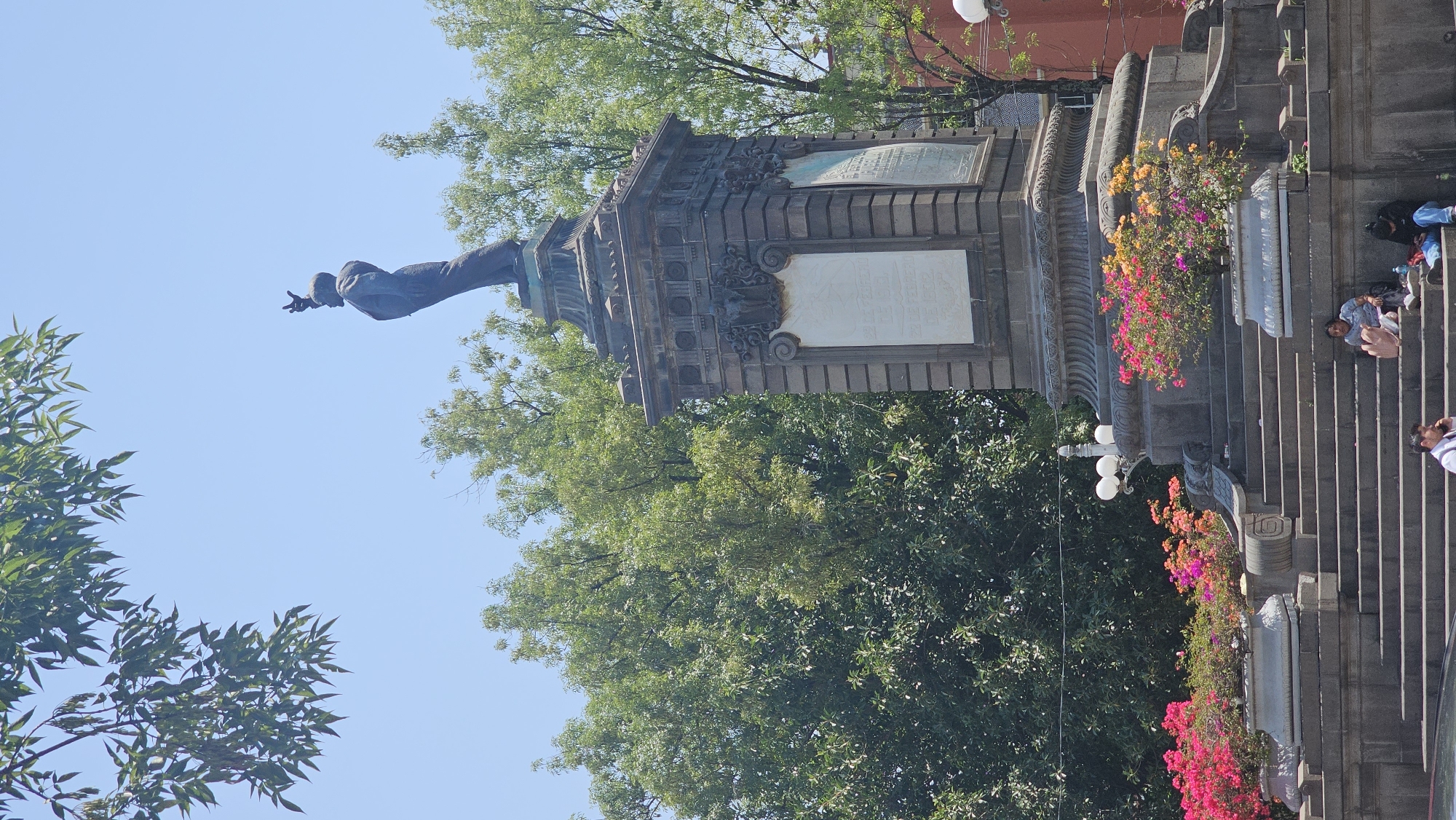 Everyday activity documented around historical monument in Puebla plaza