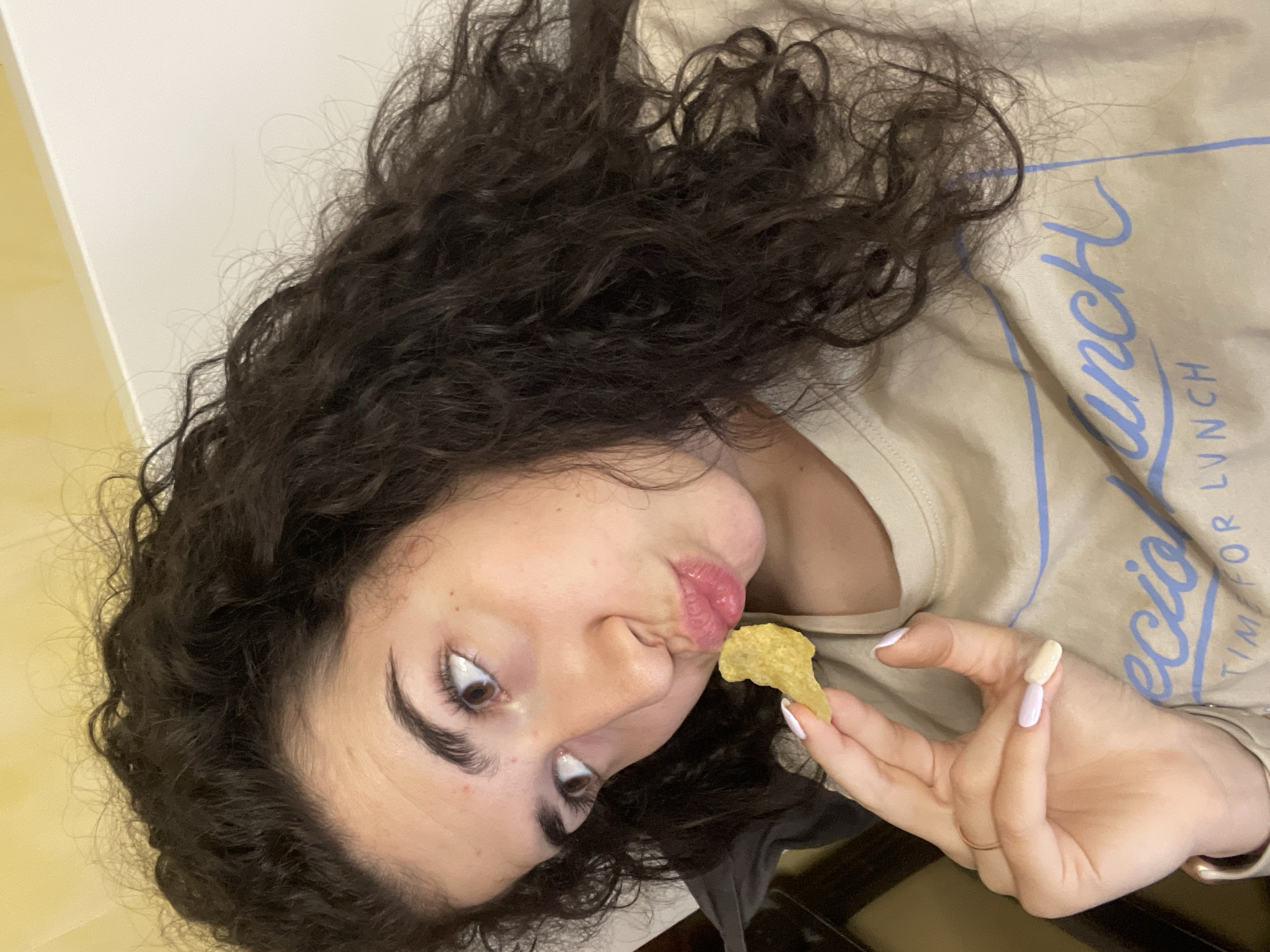 Evening routine: woman snacking, feeding excited poodle in Sofia