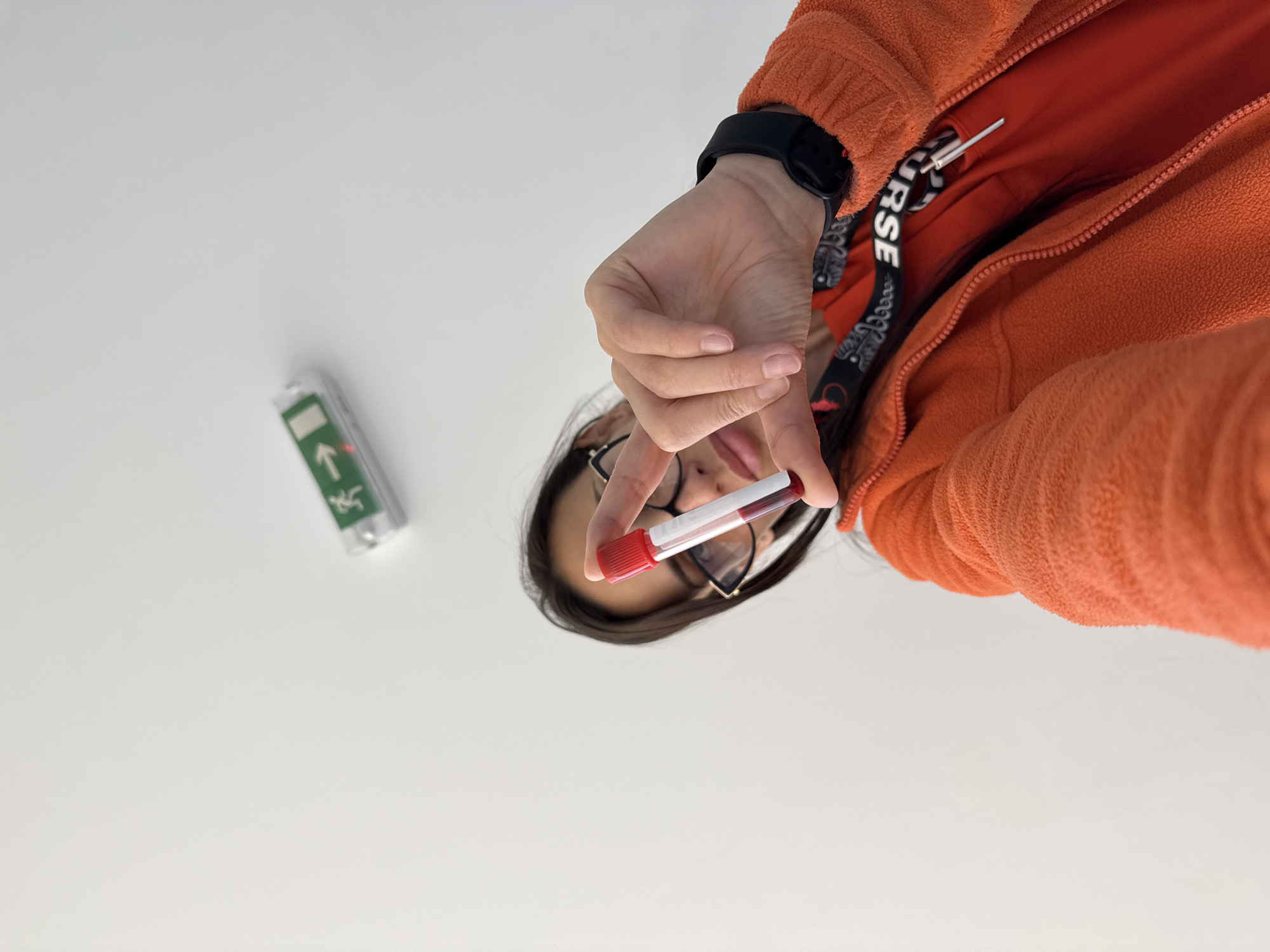 Healthcare worker handles blood sample, poses in Pleven facility