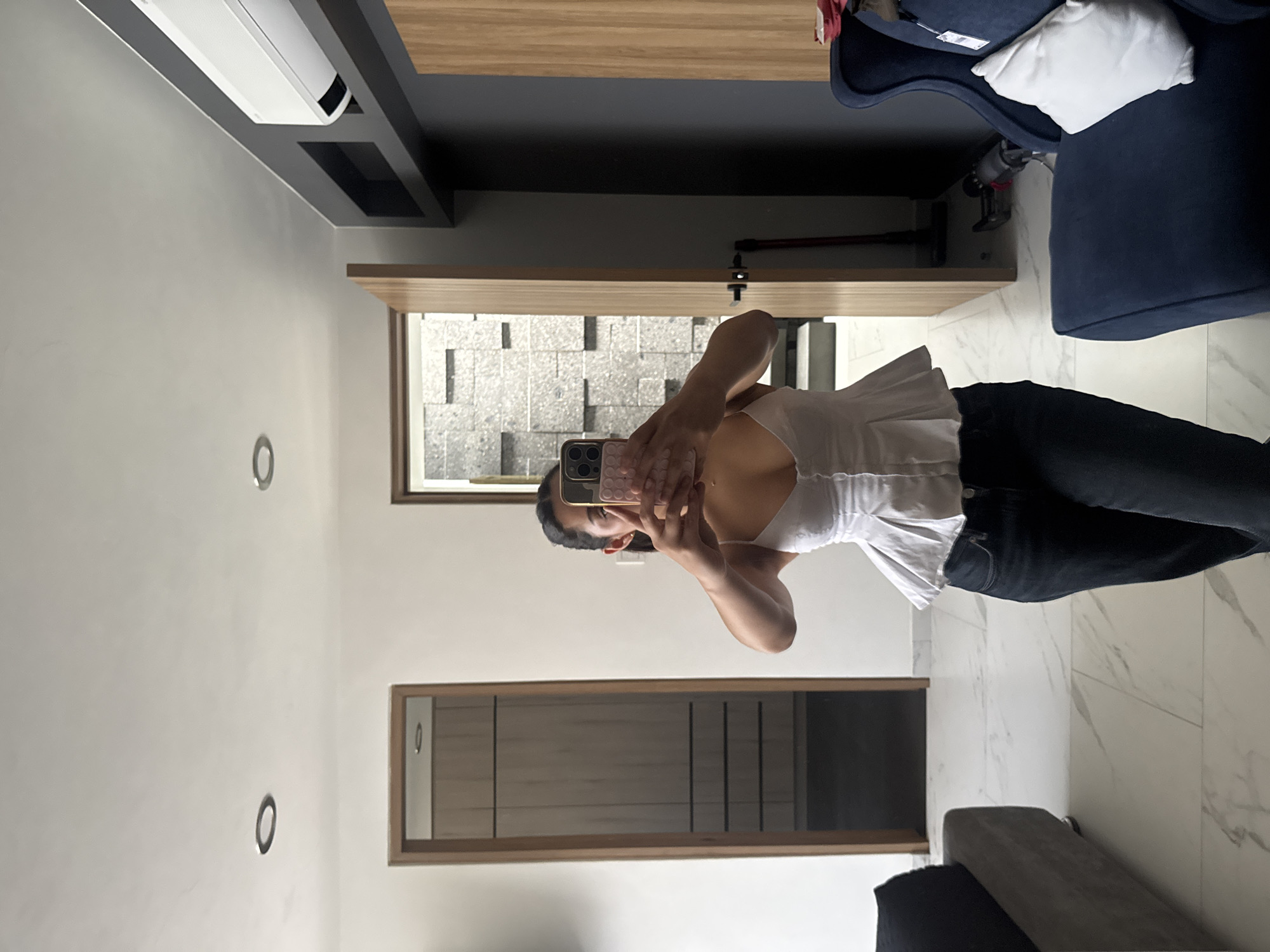 Woman takes mirror selfies in Puebla residential space