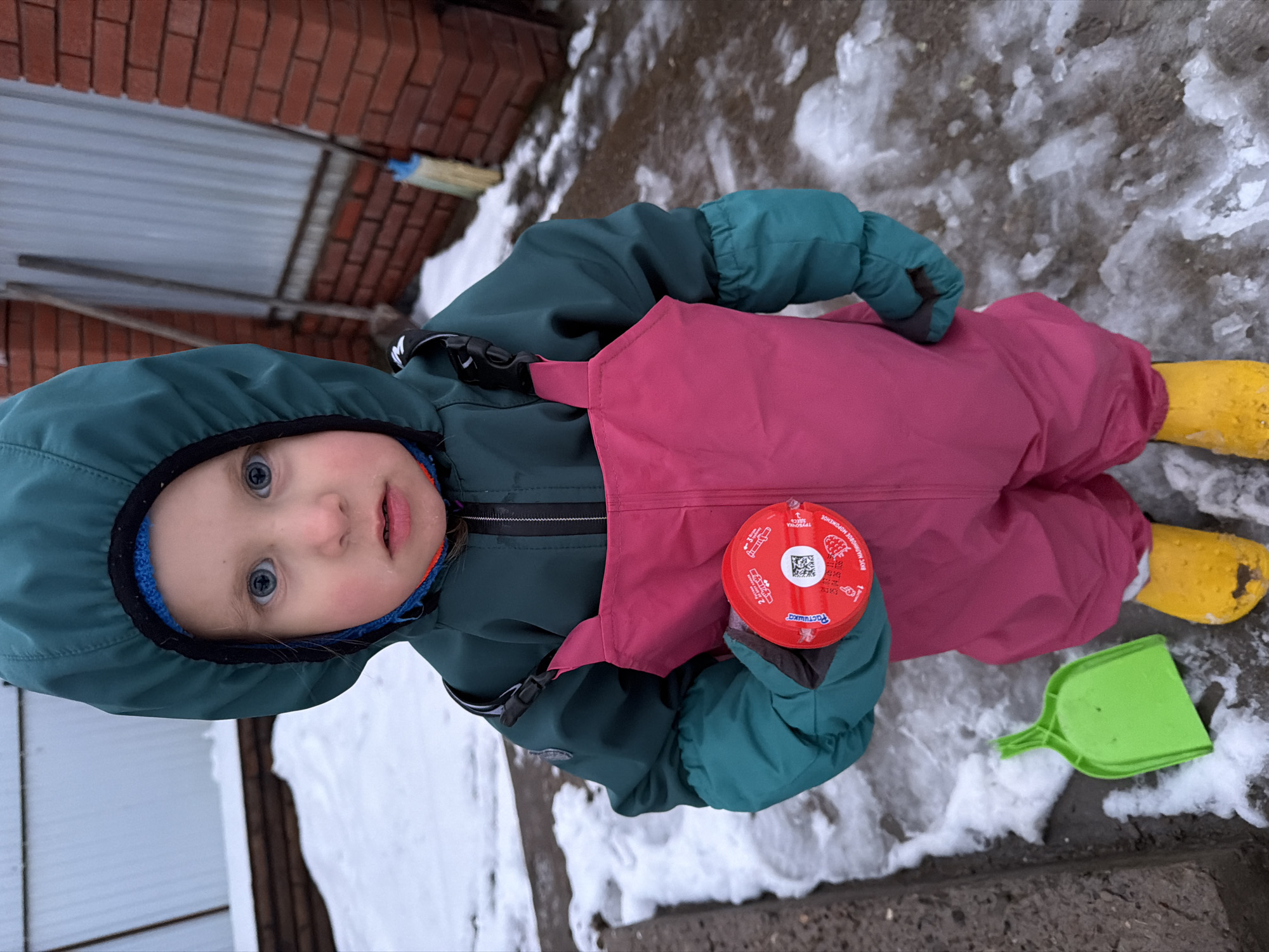 Child plays with Baby Yoda toy during mealtime in Chaikovsky