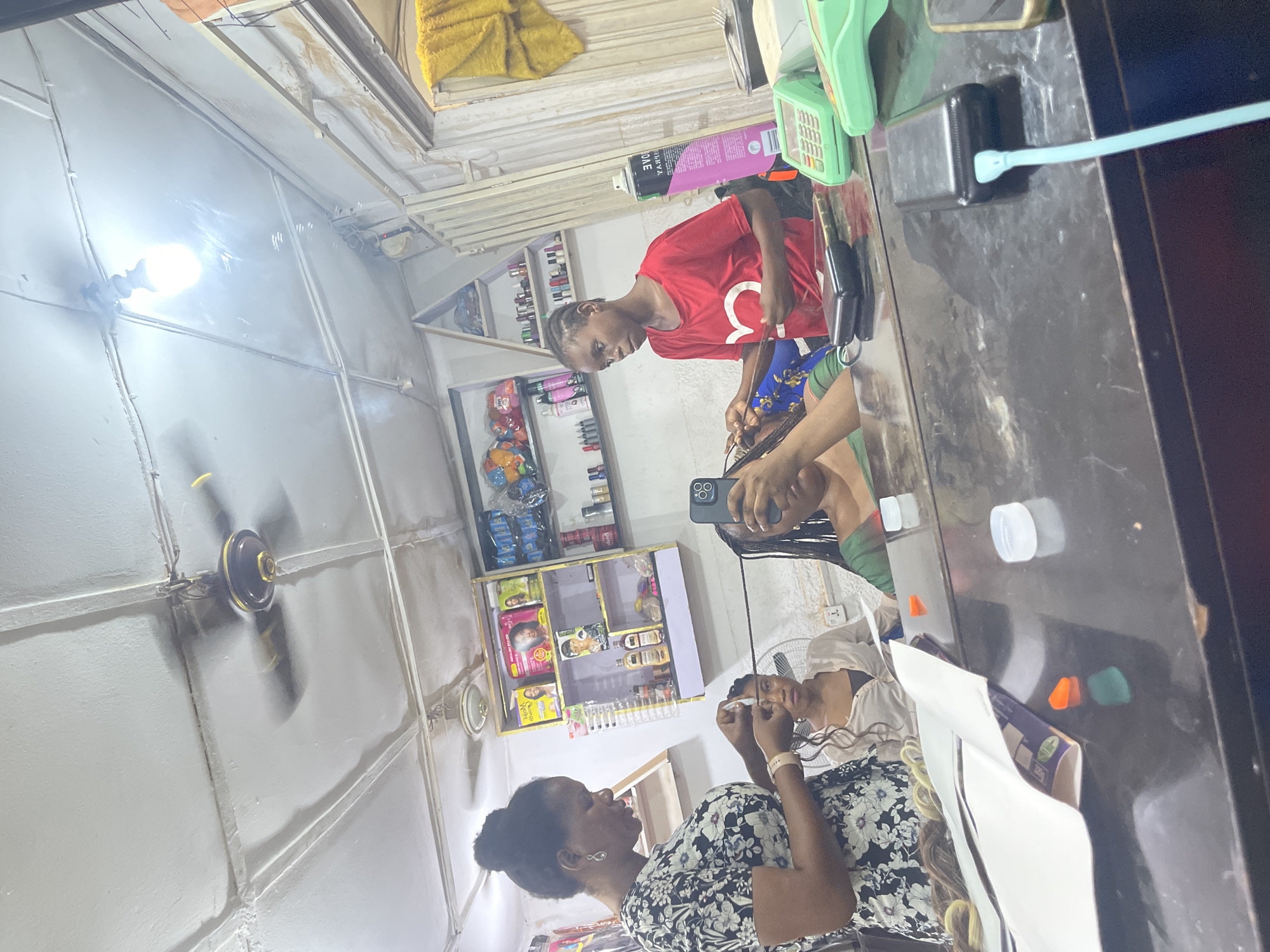 Hair salon operations documented in Abuja during evening hours