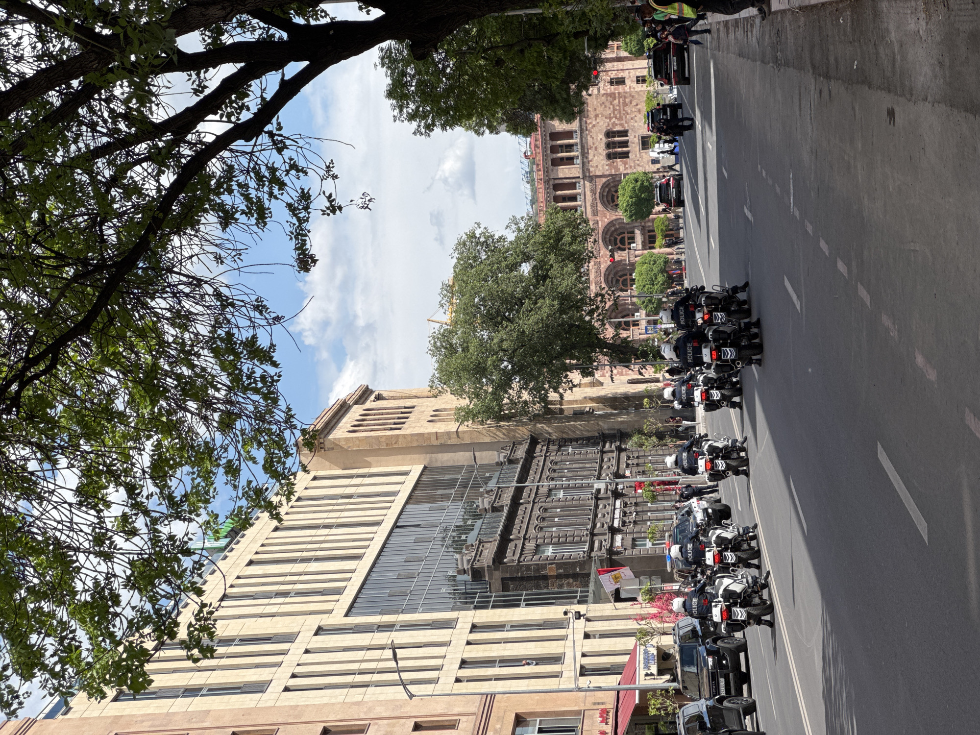 Police motorcade escorts official vehicles through central Yerevan streets