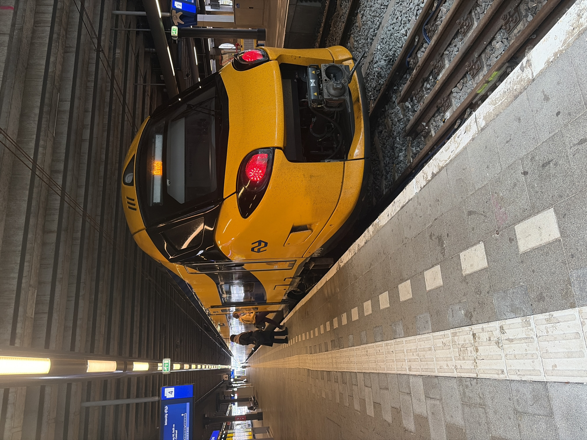 Dutch Railways train stops at modern terminal station