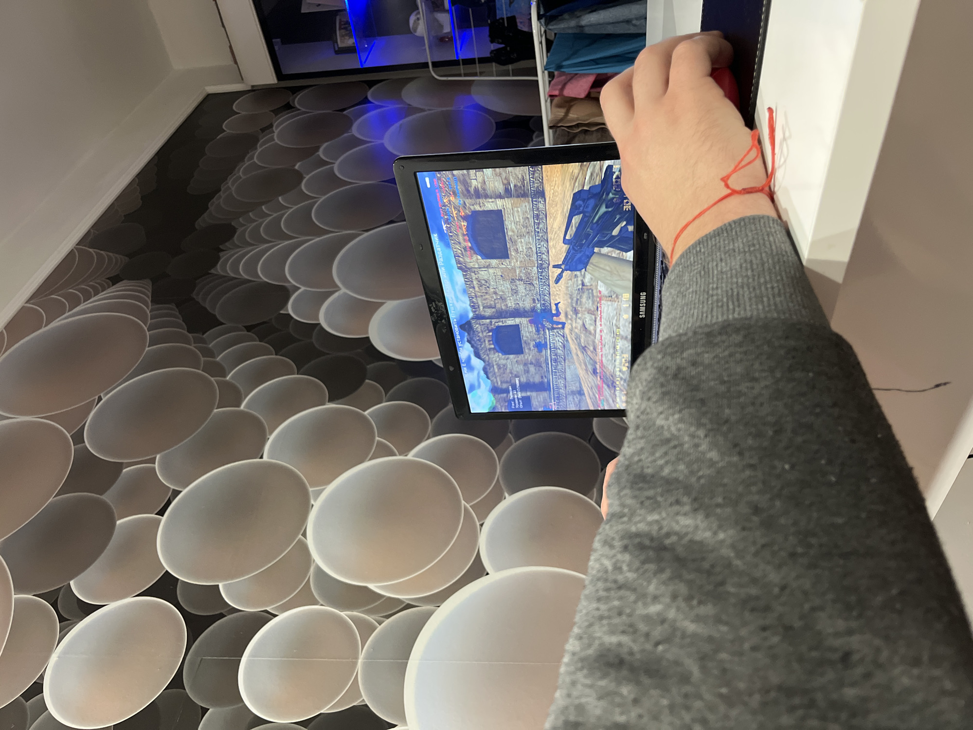 Person plays mobile shooter game on tablet in Varna