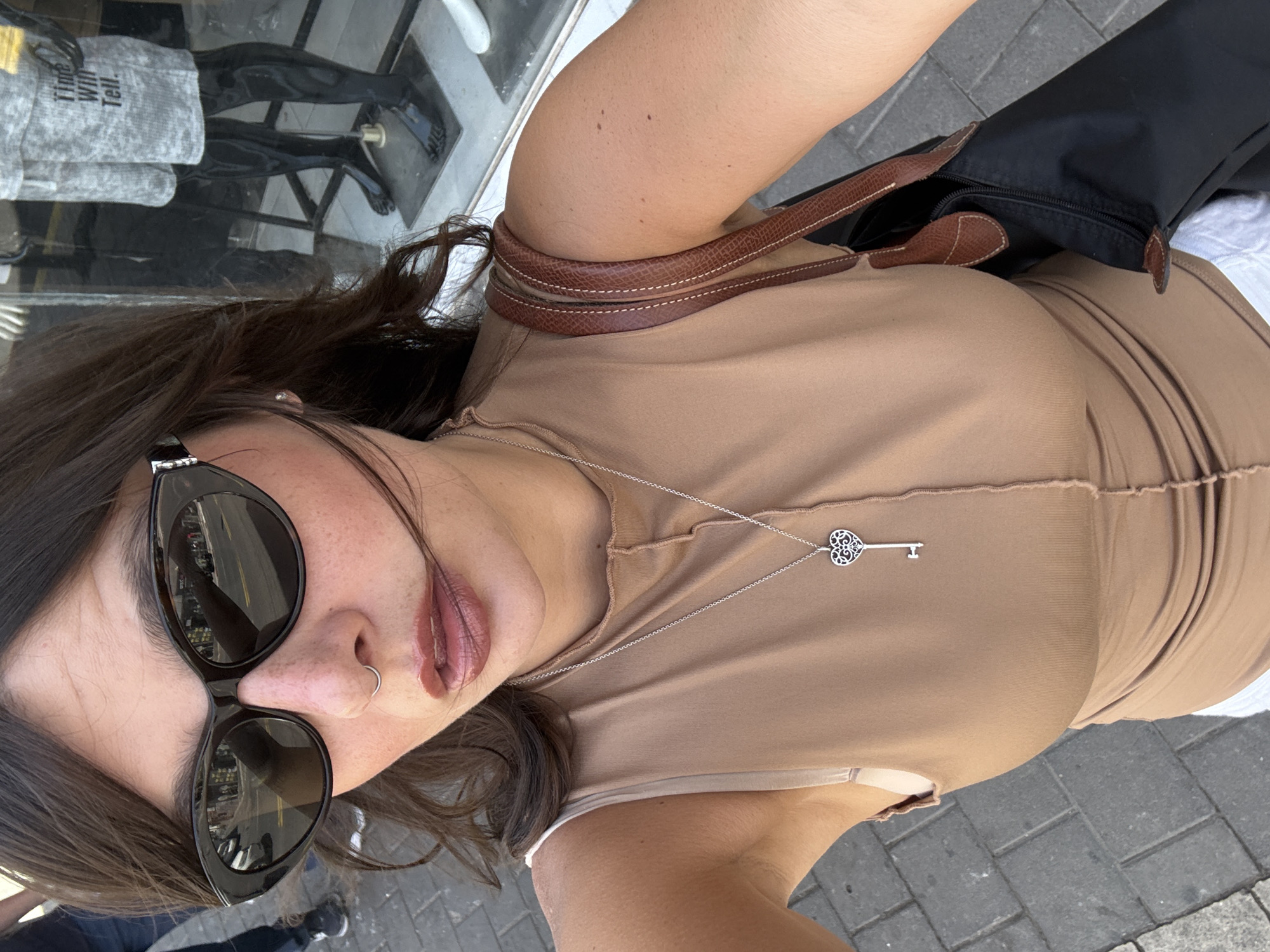 Tourist takes multiple selfies on Tel-Aviv street