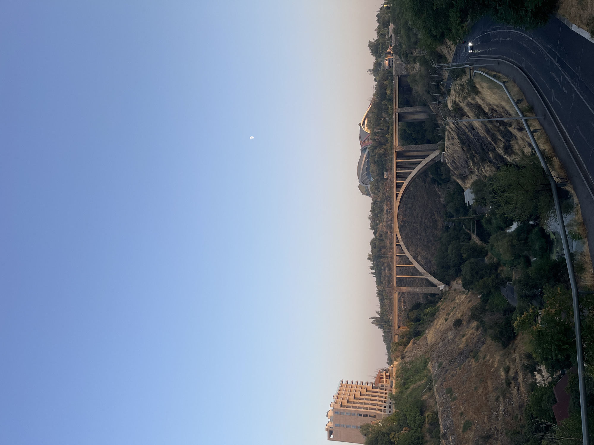 Davtashen Bridge at sunset with crescent moon, Yerevan