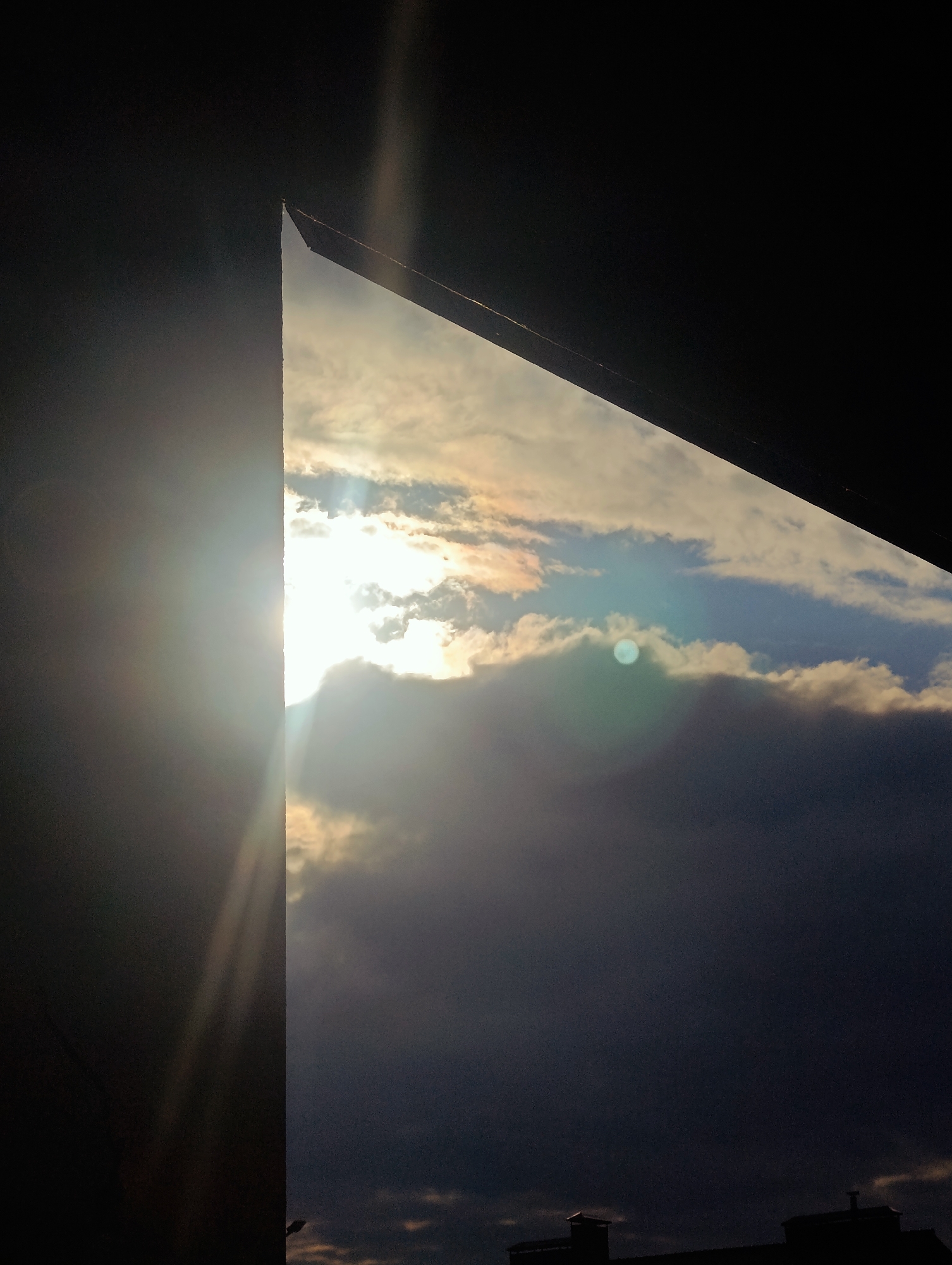 Early morning sky and cityscape through breaking cloud cover