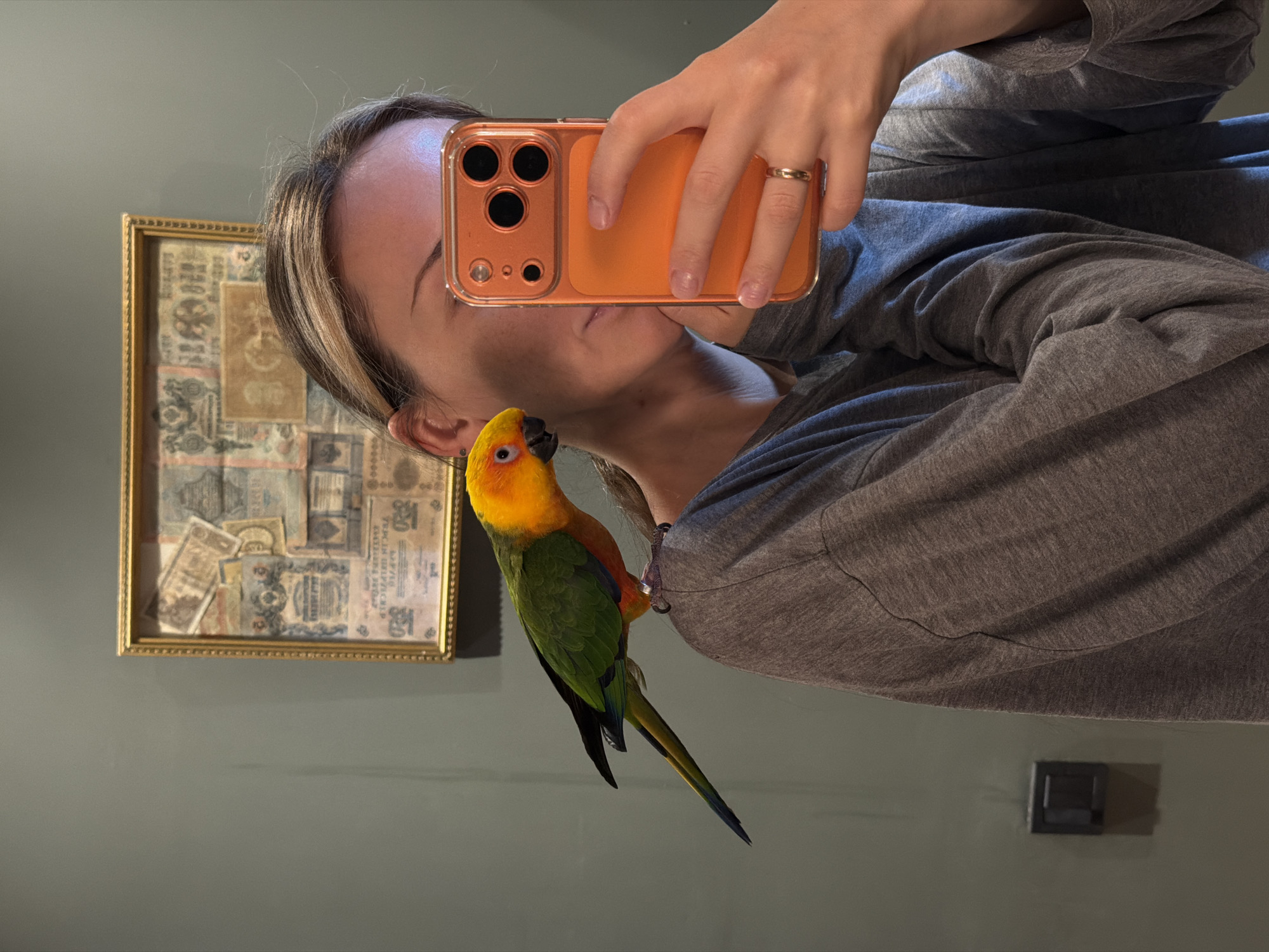 Mirror selfie captured with orange smartphone in Khimki, Russia