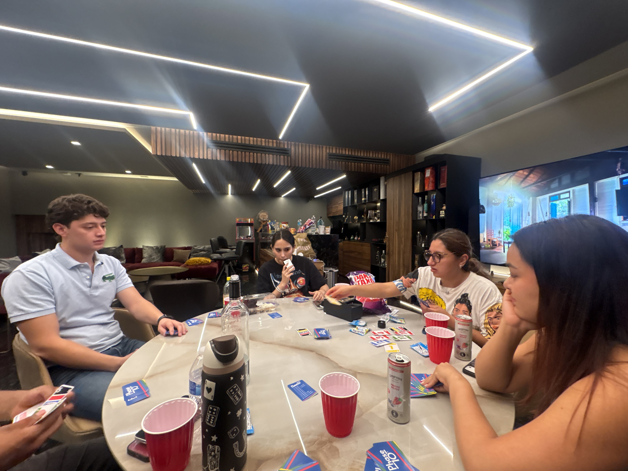 Friends play Phase 10 card game in Mexico morning