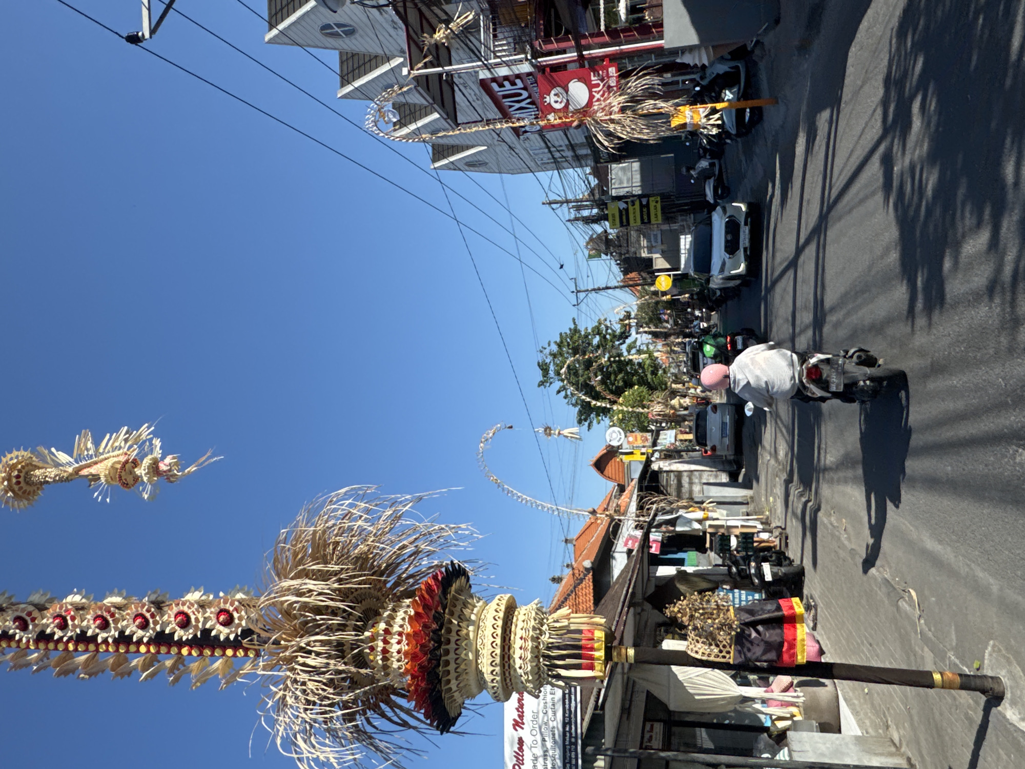 North Kuta street traffic and penjor decorations on a sunny morning