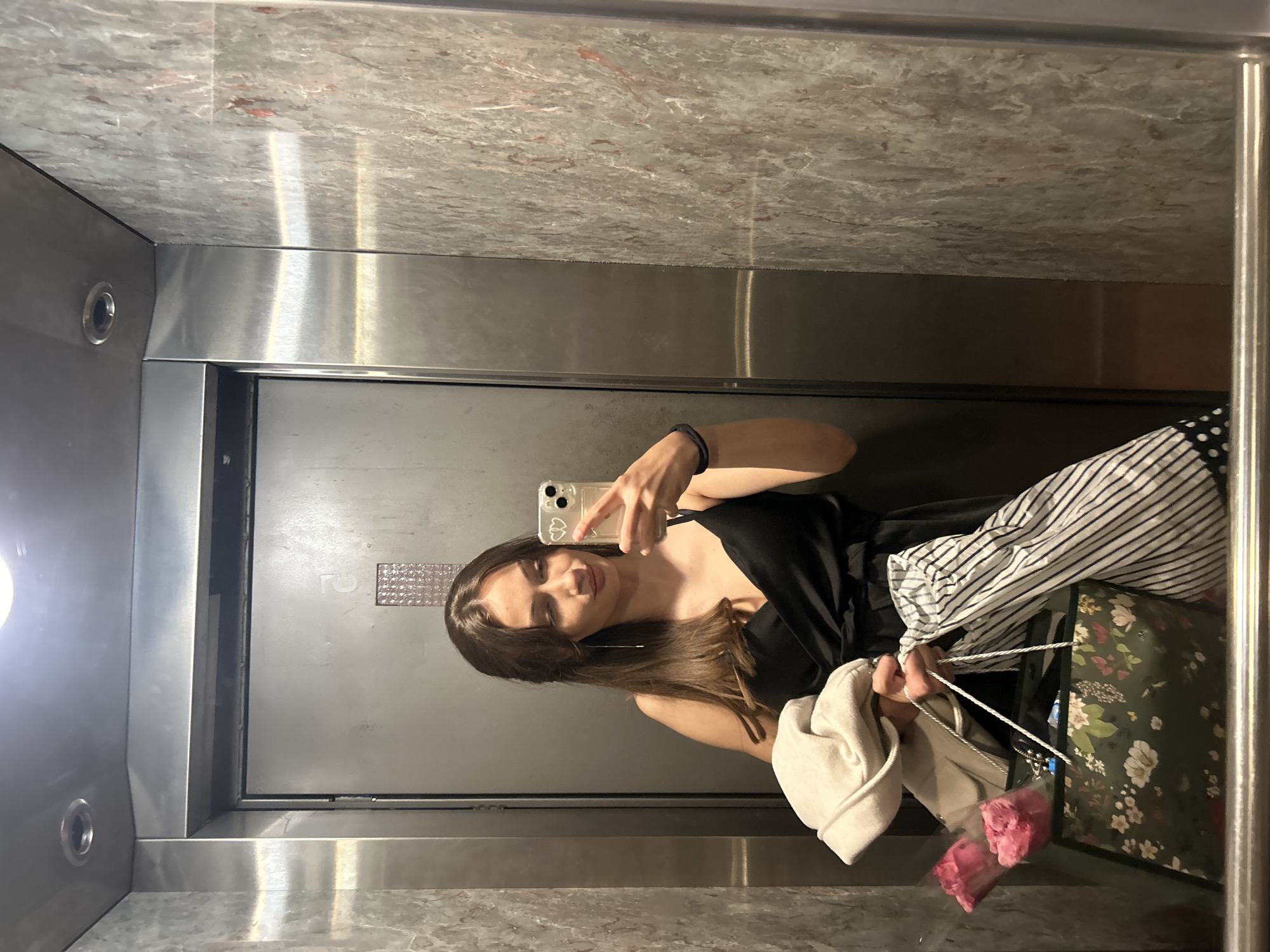 Woman takes elevator selfie with shopping bags in Burgas