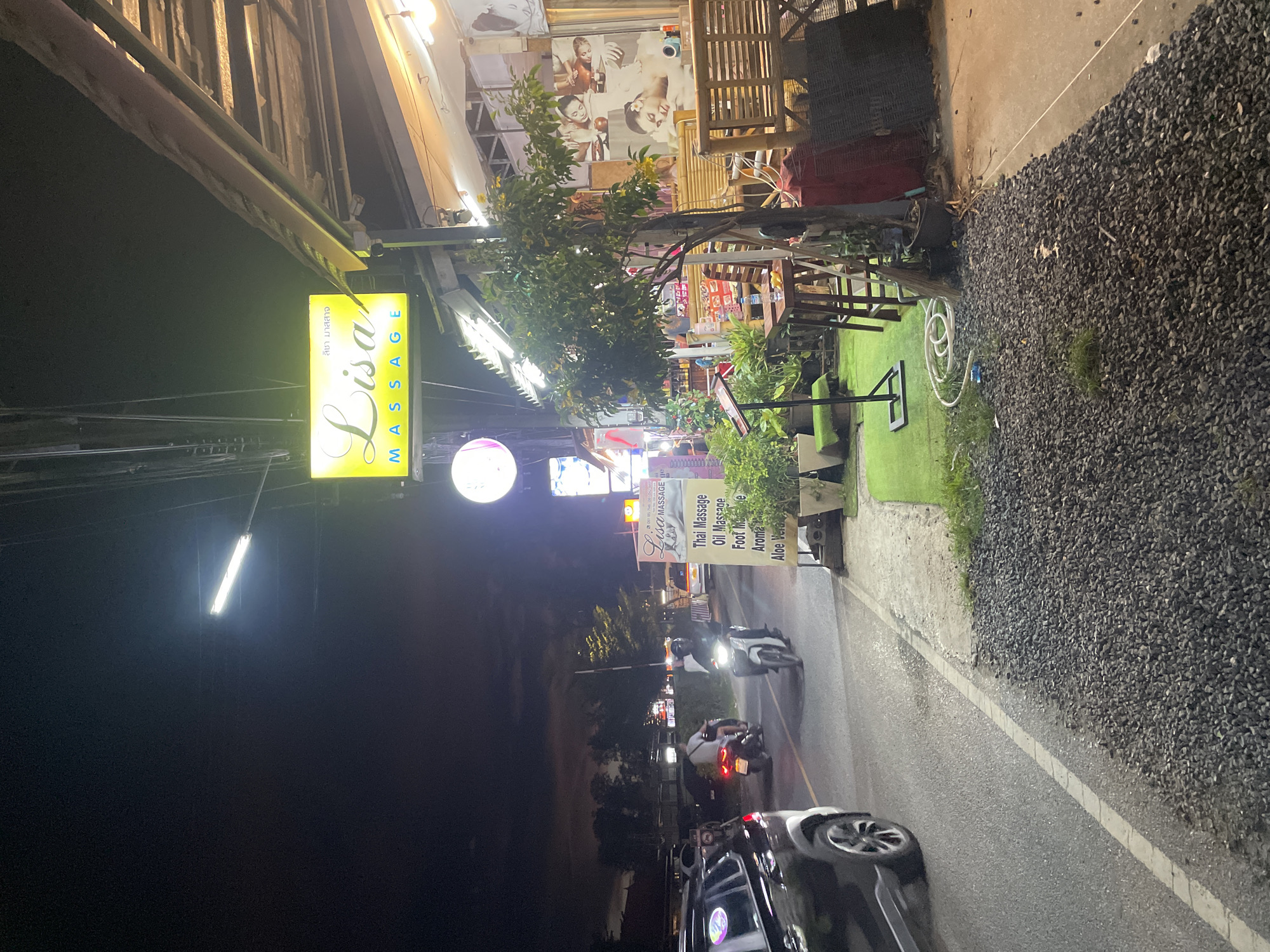 Illuminated massage parlor observed during nighttime in Choeng Thale