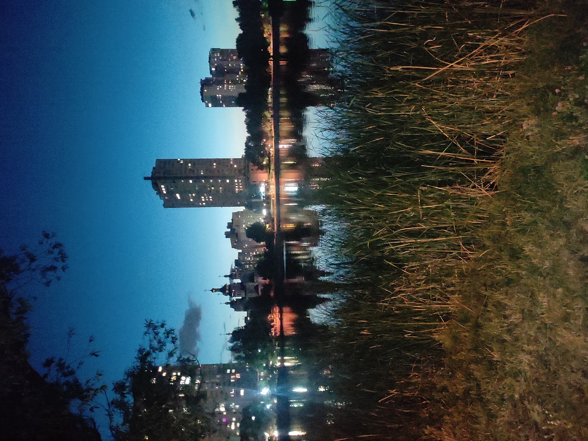 Kyiv's Obolonska embankment at dusk on a July evening