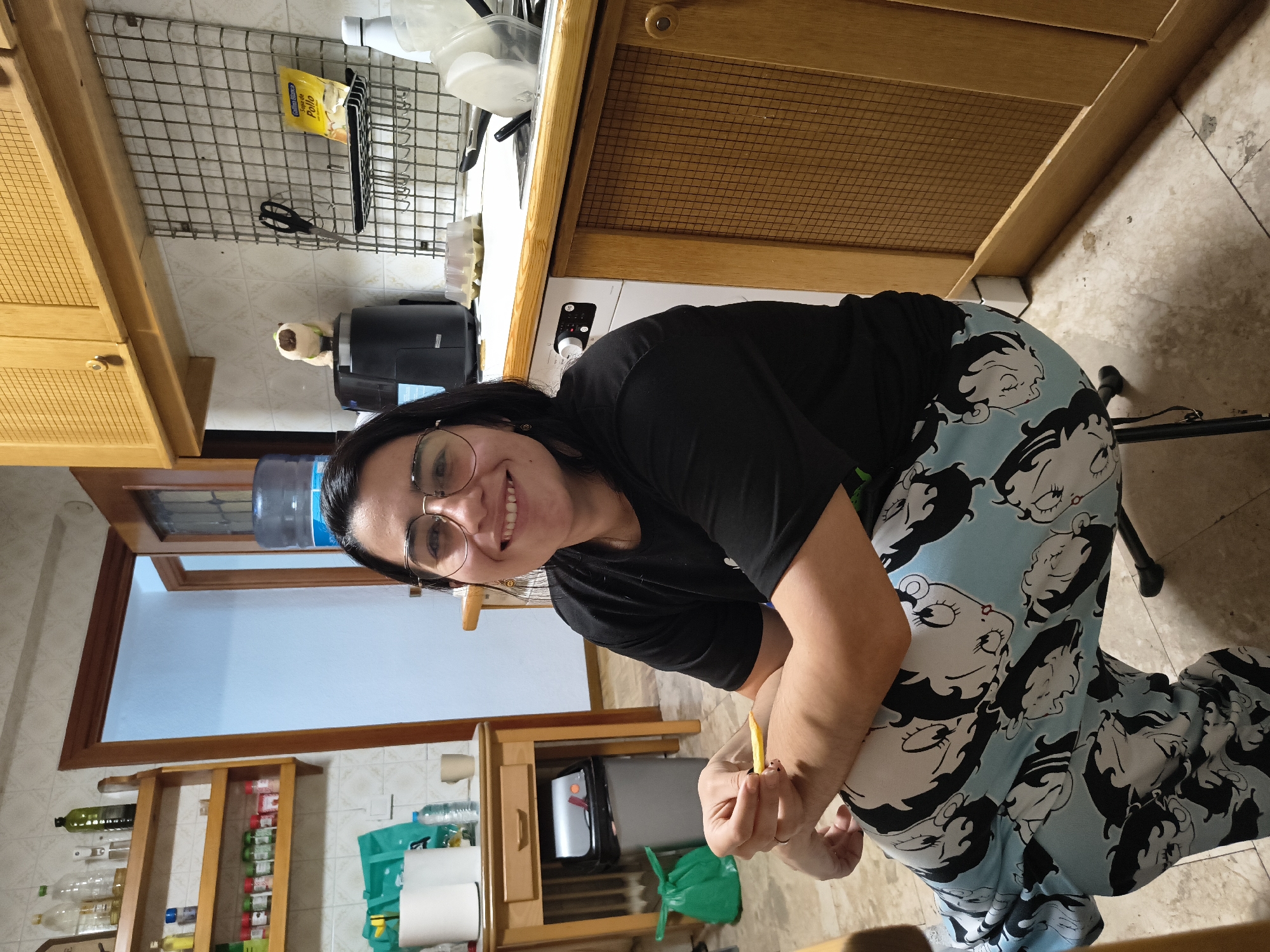 Woman photographed smiling with yellow object in Guadalajara kitchen