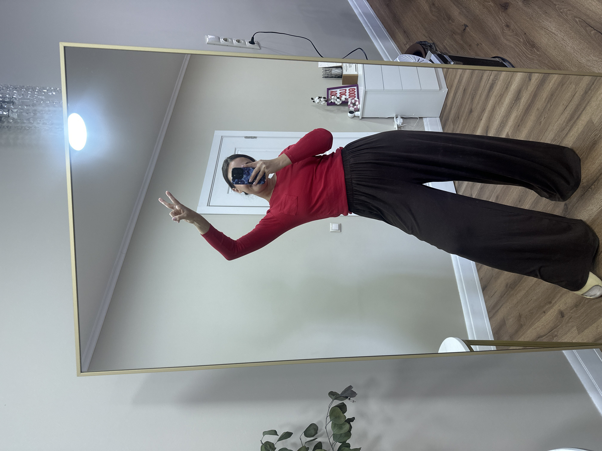 Person takes mirror selfie with peace sign in Surgut
