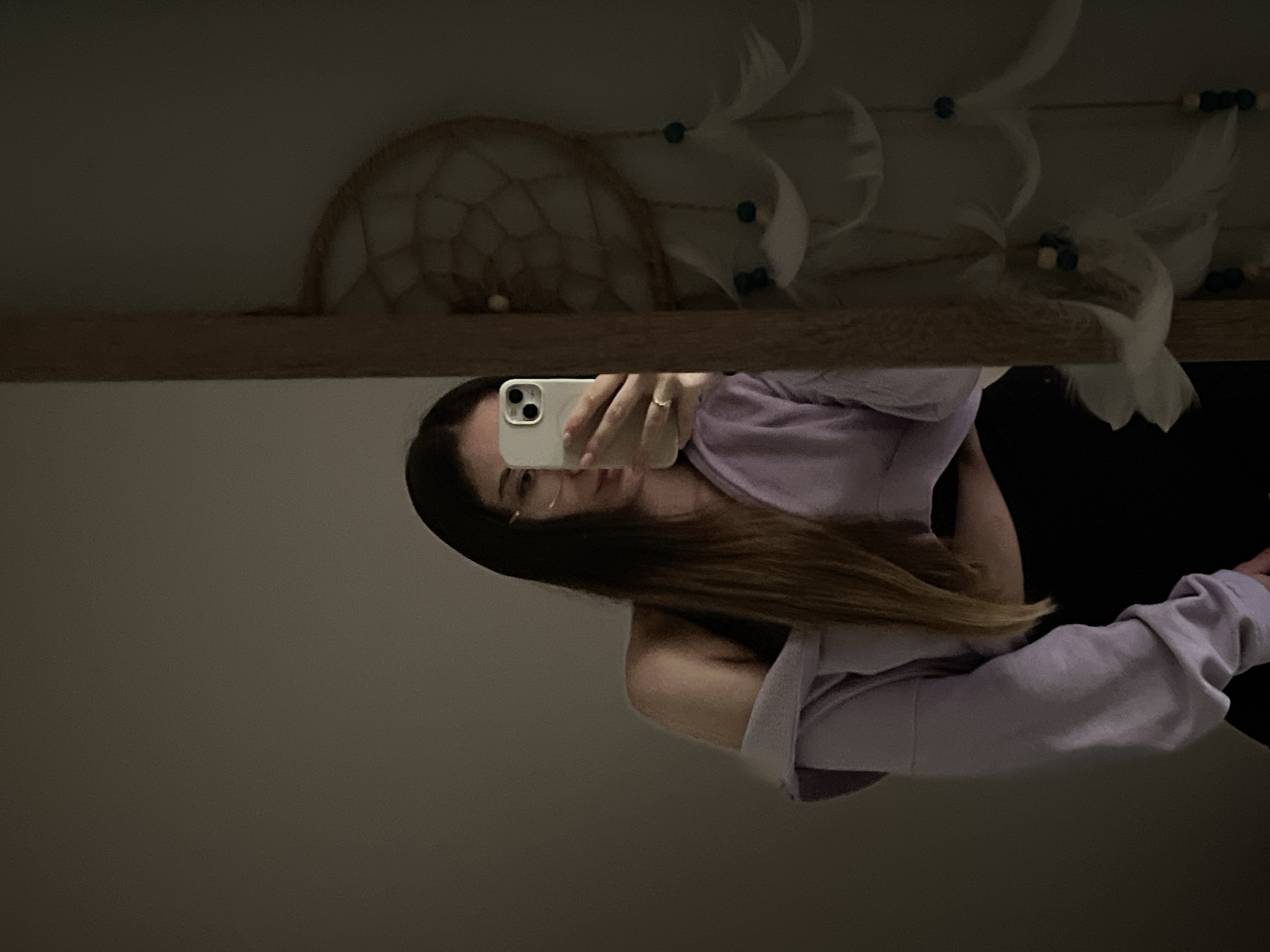 Woman Takes Mirror Selfies in Purple Sweatshirt