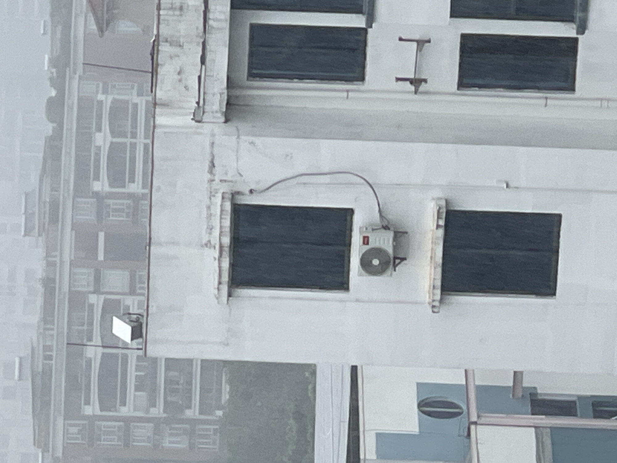 Rainy rooftop views across Panyu District's urban residential fabric