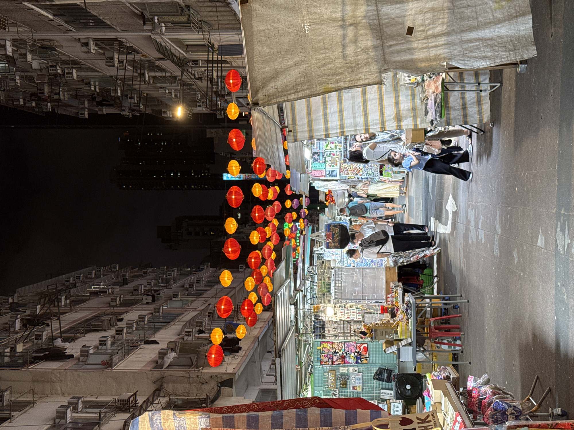 Traditional night market bustles under lanterns in Hong Kong