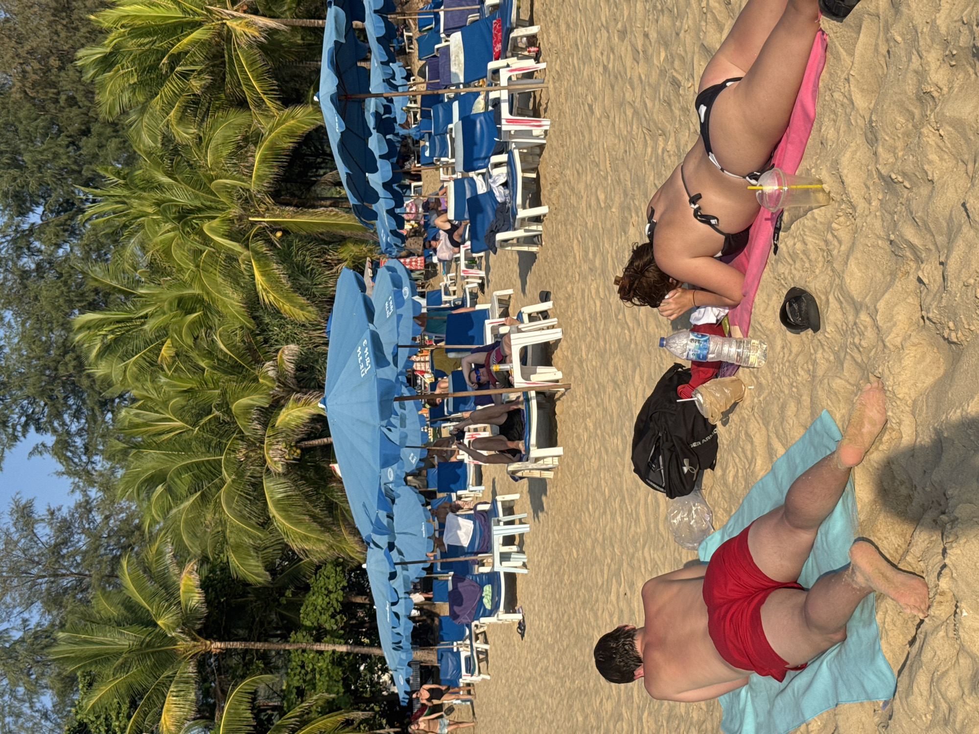 Sunbathers relax at Karon Beach in Thailand