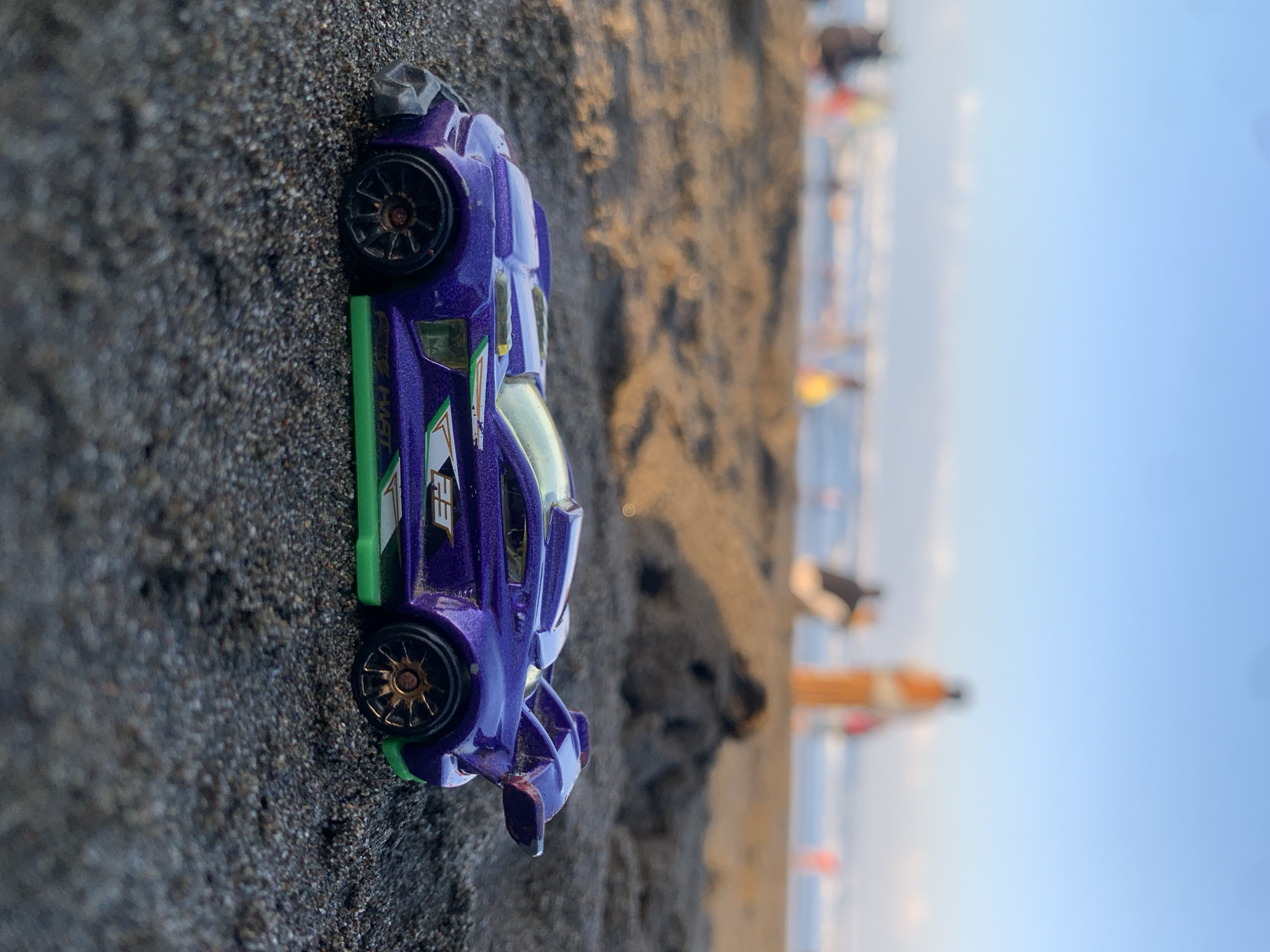 Hot Wheels toy car photographed on Indonesian beach