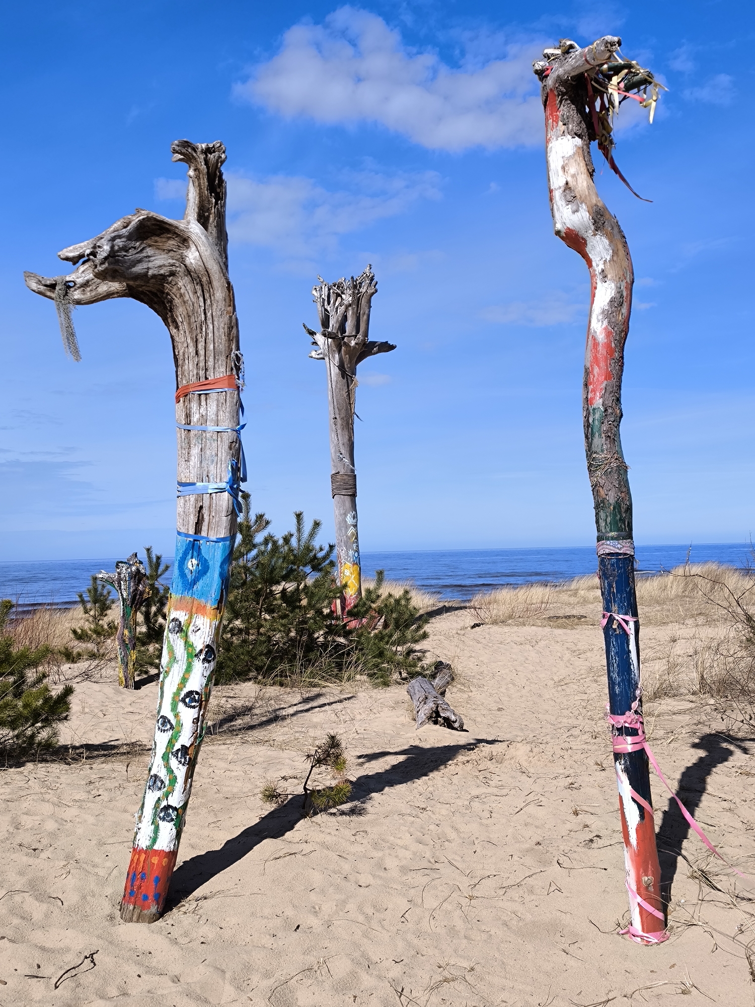 Woman documents colorful beach art installation in Gauja, Latvia