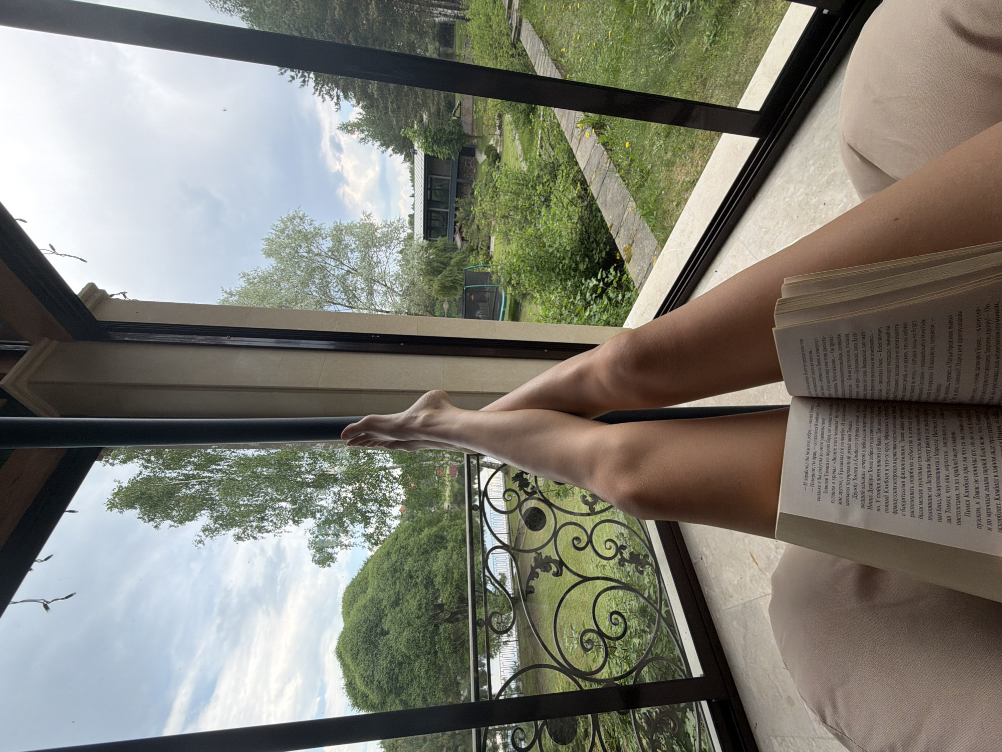 Woman enjoys quiet reading time on porch in Shchelkovo