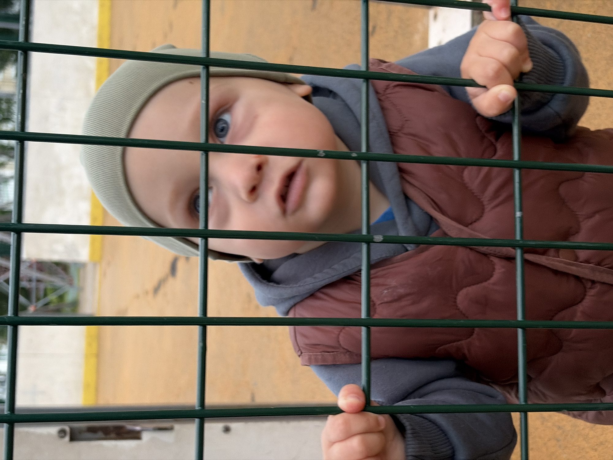 Toddler plays outside amid everyday residential life in Moskovskiy
