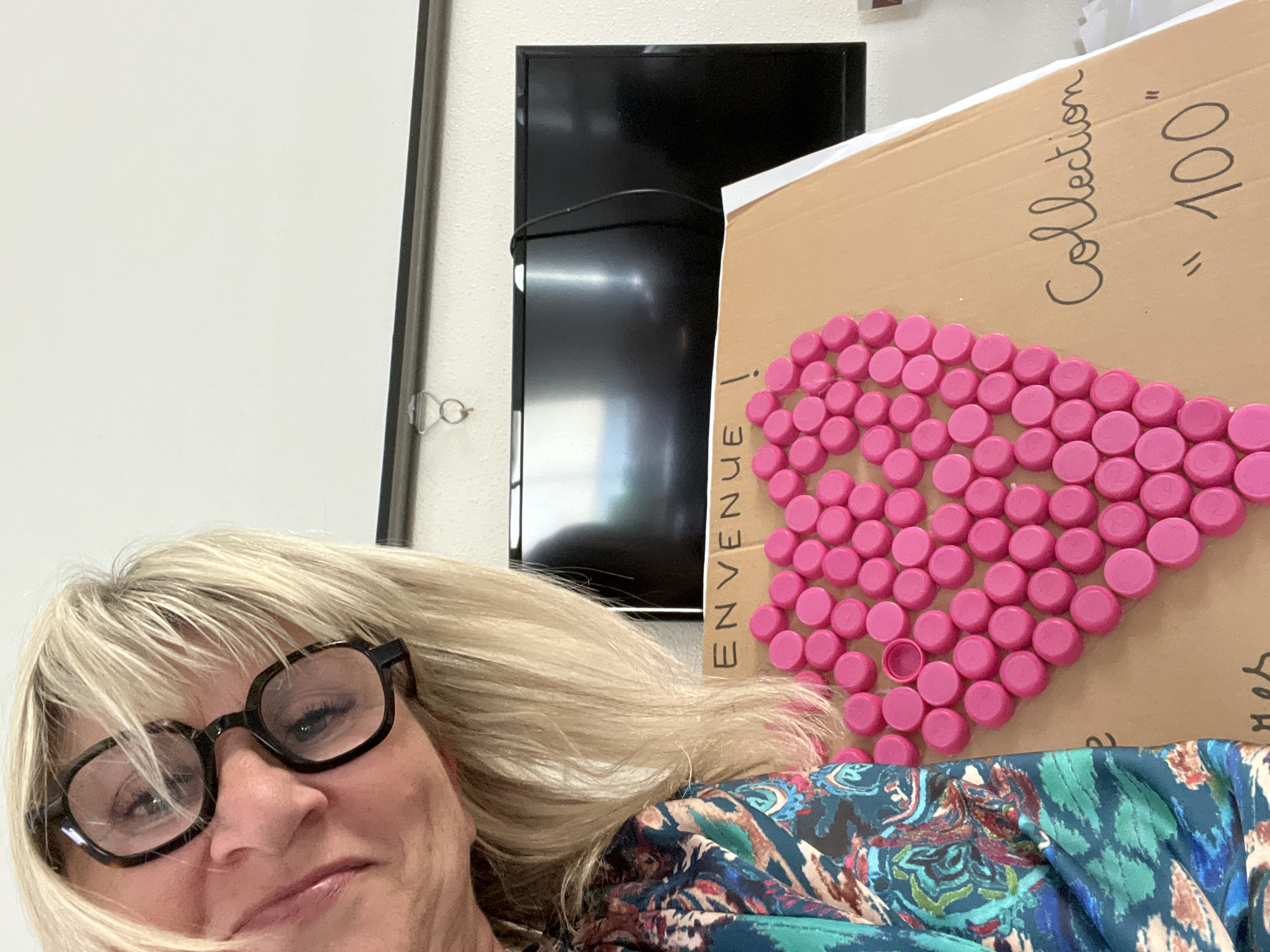 Woman documents colorful bottle cap collection project in France