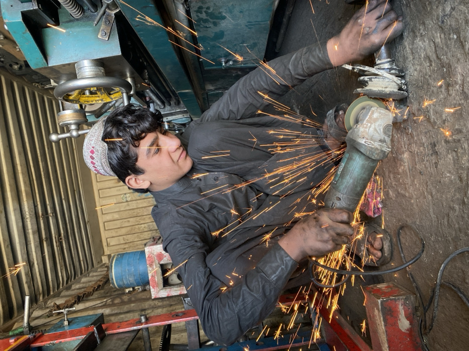 Young craftsmen work in Kandahar metalworking shops during morning hours