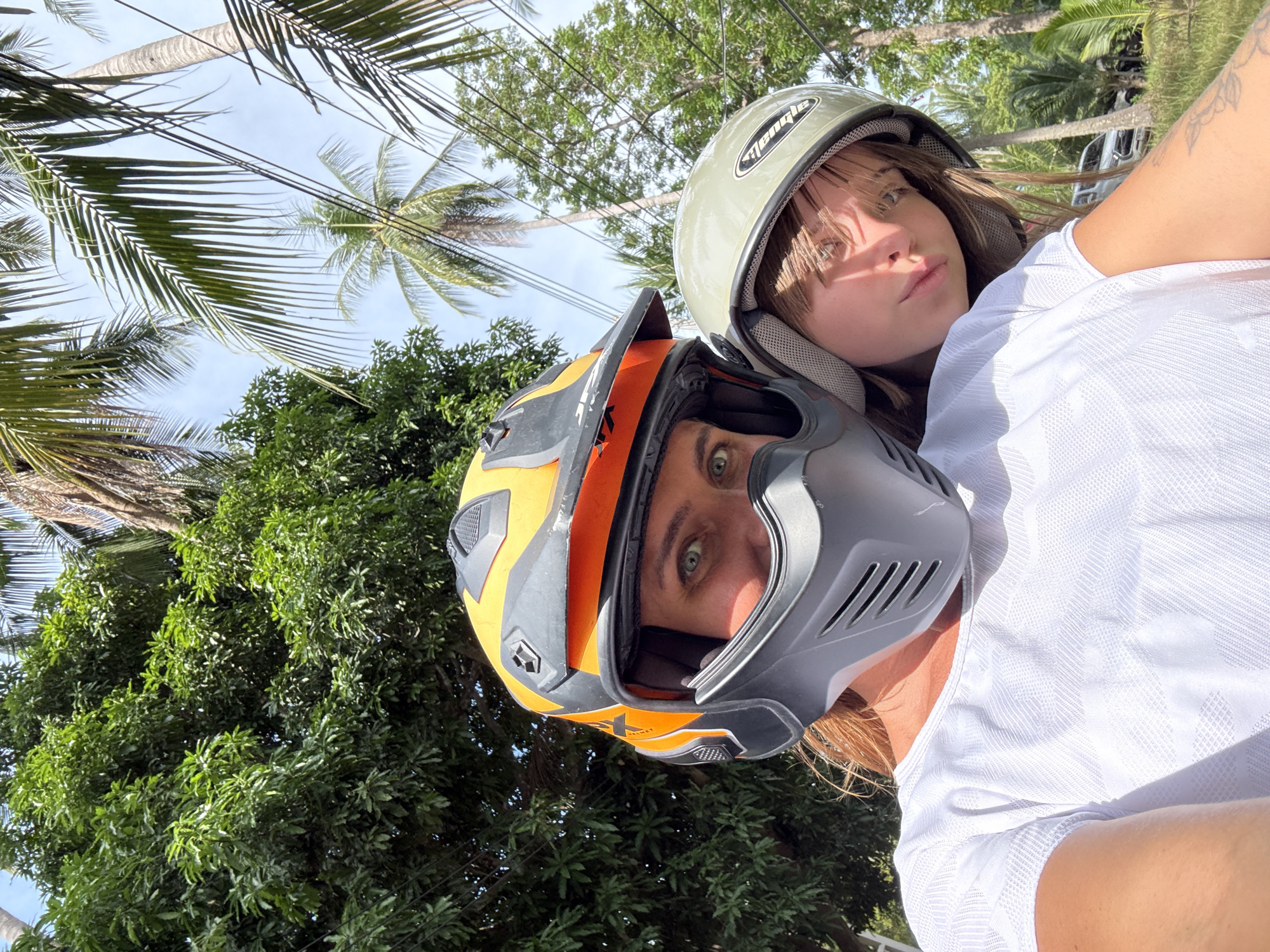 Scooter selfie on a palm-lined road in Ko Samui
