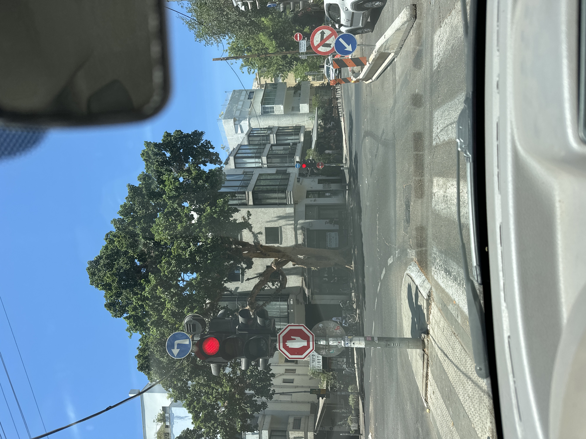 Red light at a Tel Aviv intersection, viewed from inside a car