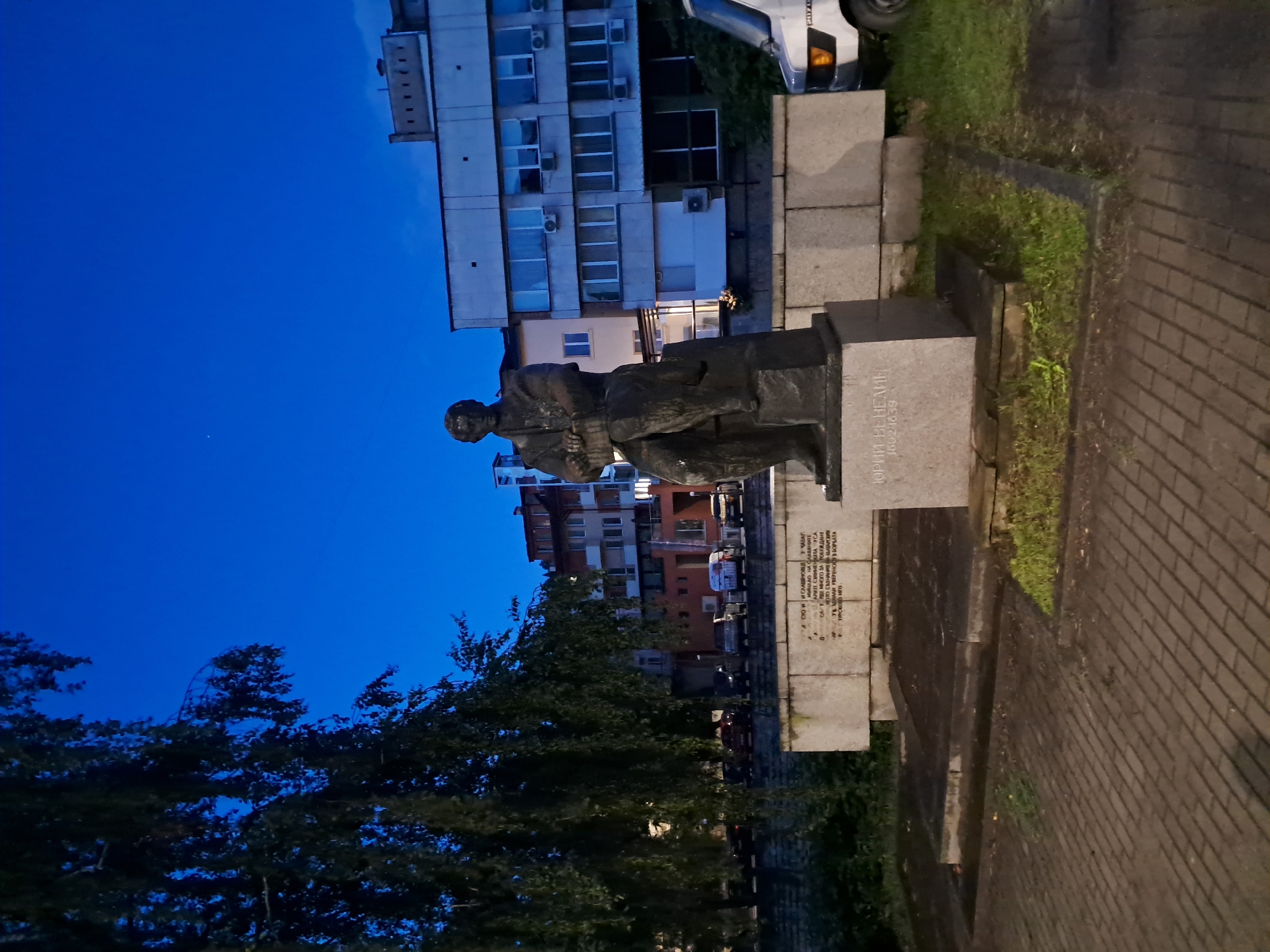 Bronze statue of historical figure observed in urban setting