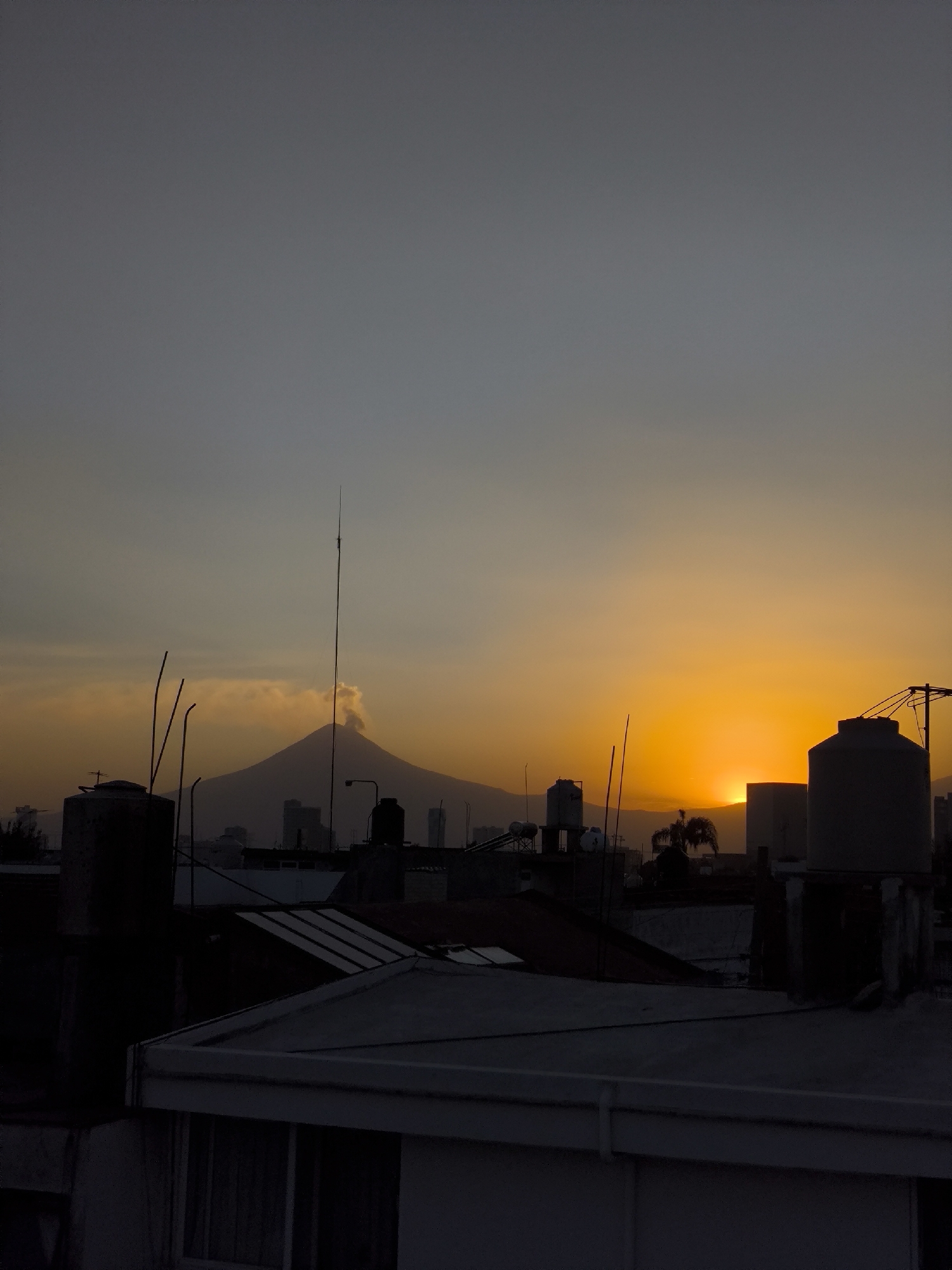 Sunset view captured from Puebla rooftop showing Popocatépetl volcano