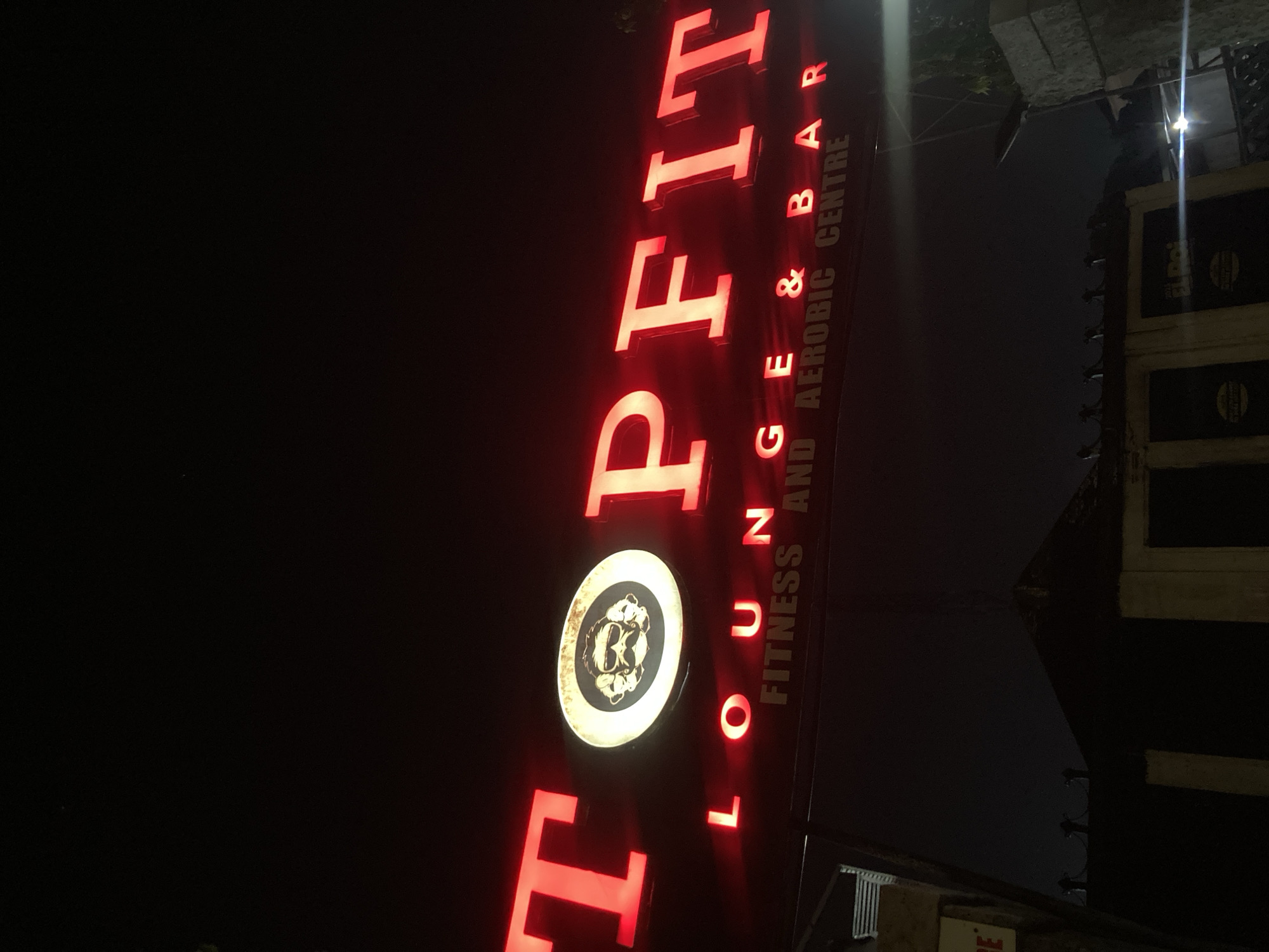 Neon-lit nightlife outside a Gwarinpa lounge bar