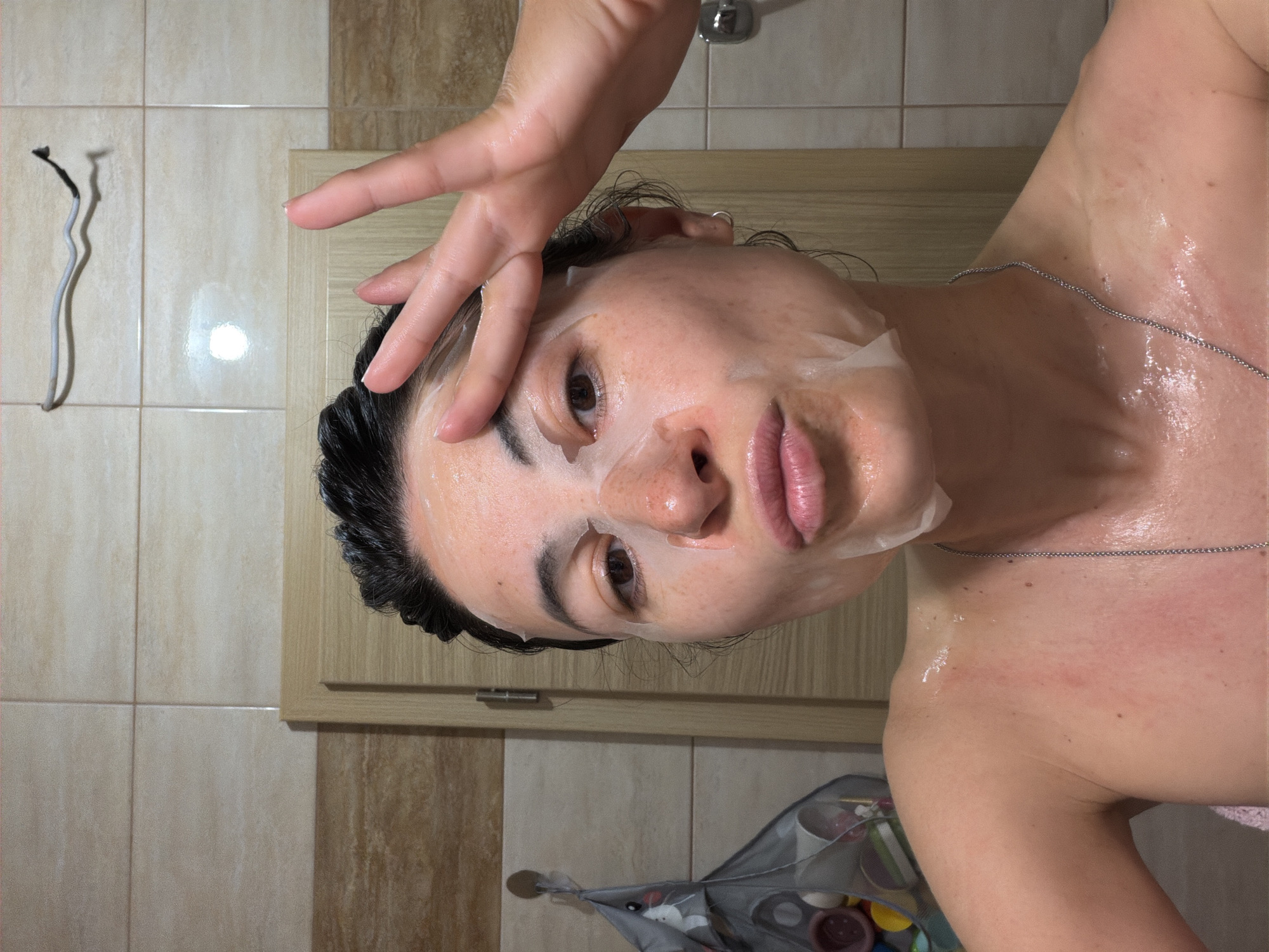Woman conducts evening skincare routine in Budva bathroom