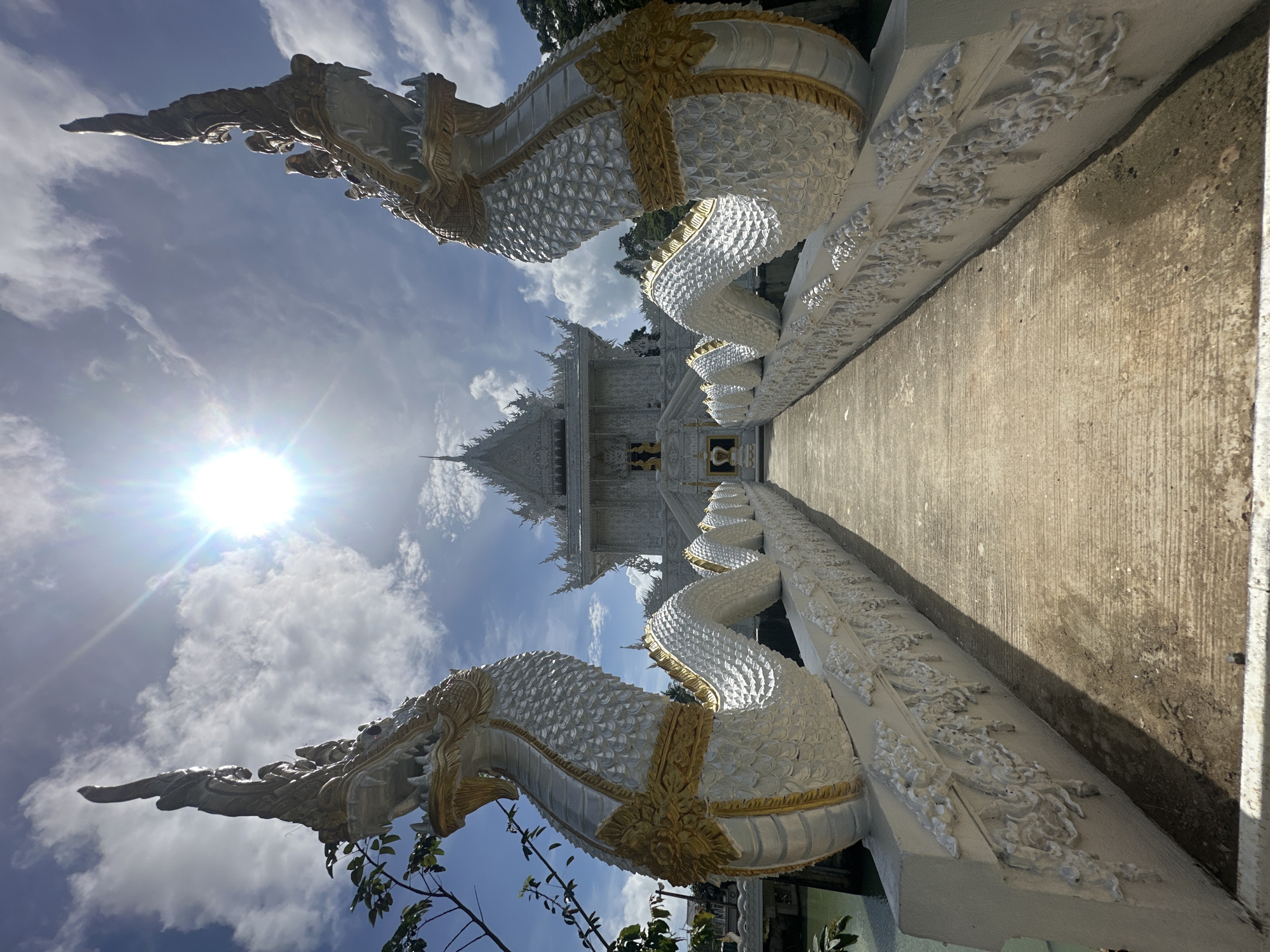 Ornate white temple in Thep Krasatti on a sunny morning